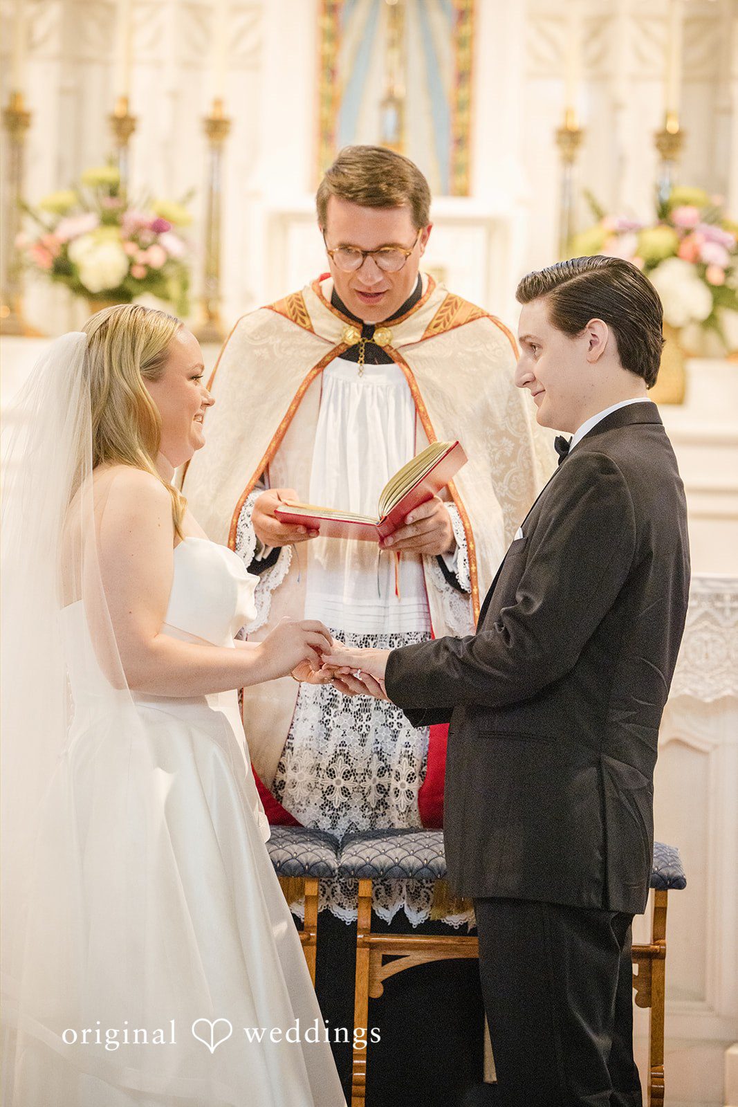 Nicole + Matt An officiant speaking to a bride and groom during their wedding ceremony at the altar.