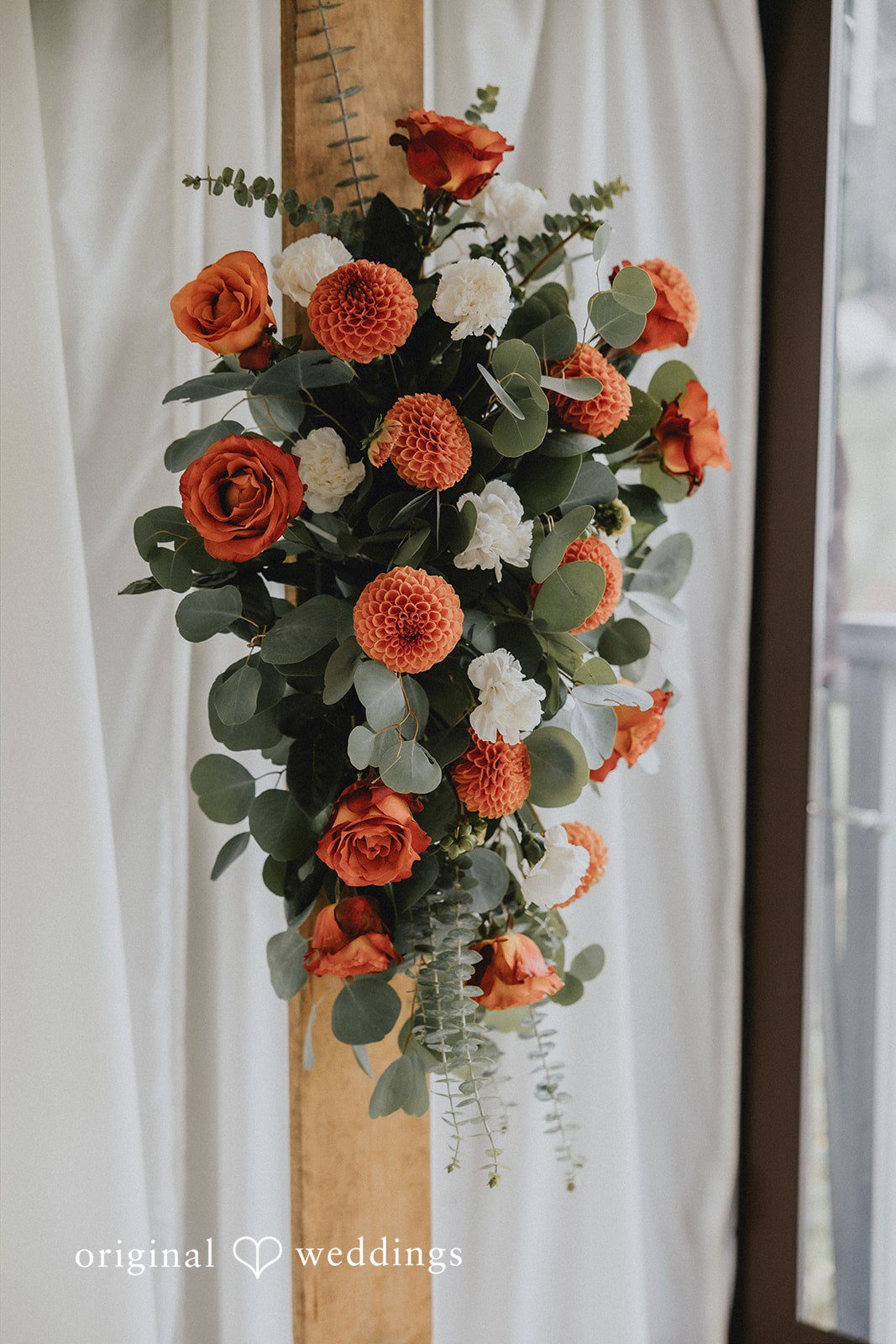 A tall floral arrangement featuring pink and orange flowers.