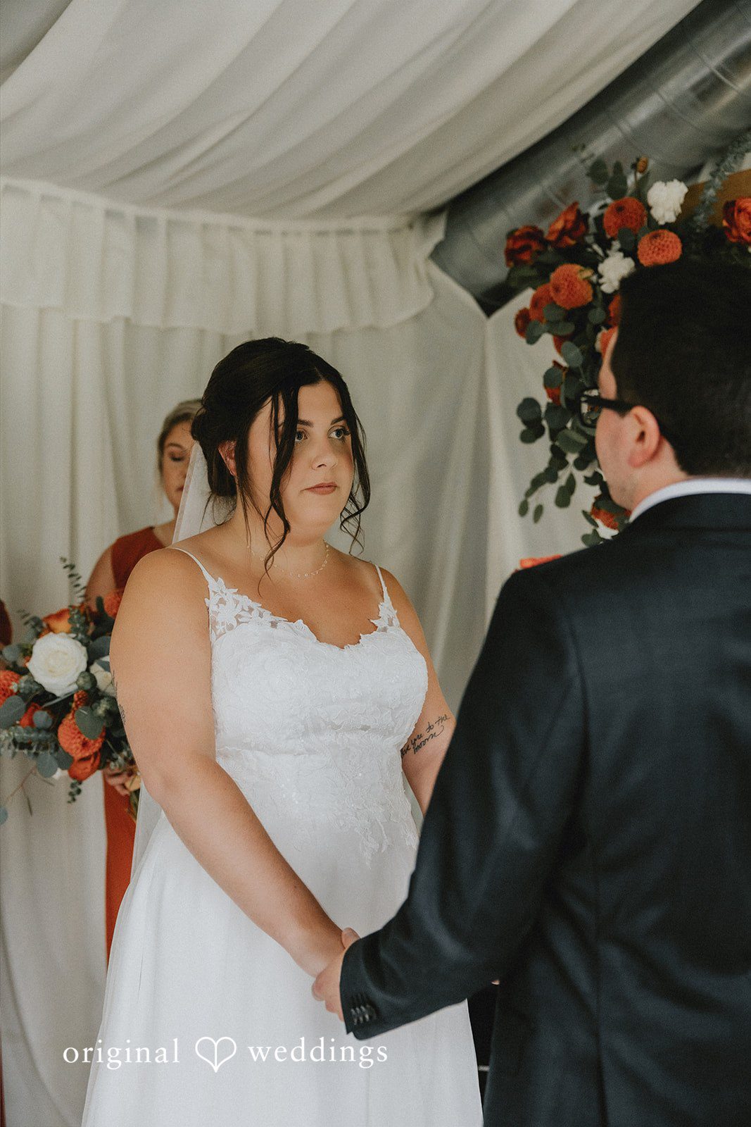 A bride and groom standing together during their wedding ceremony.