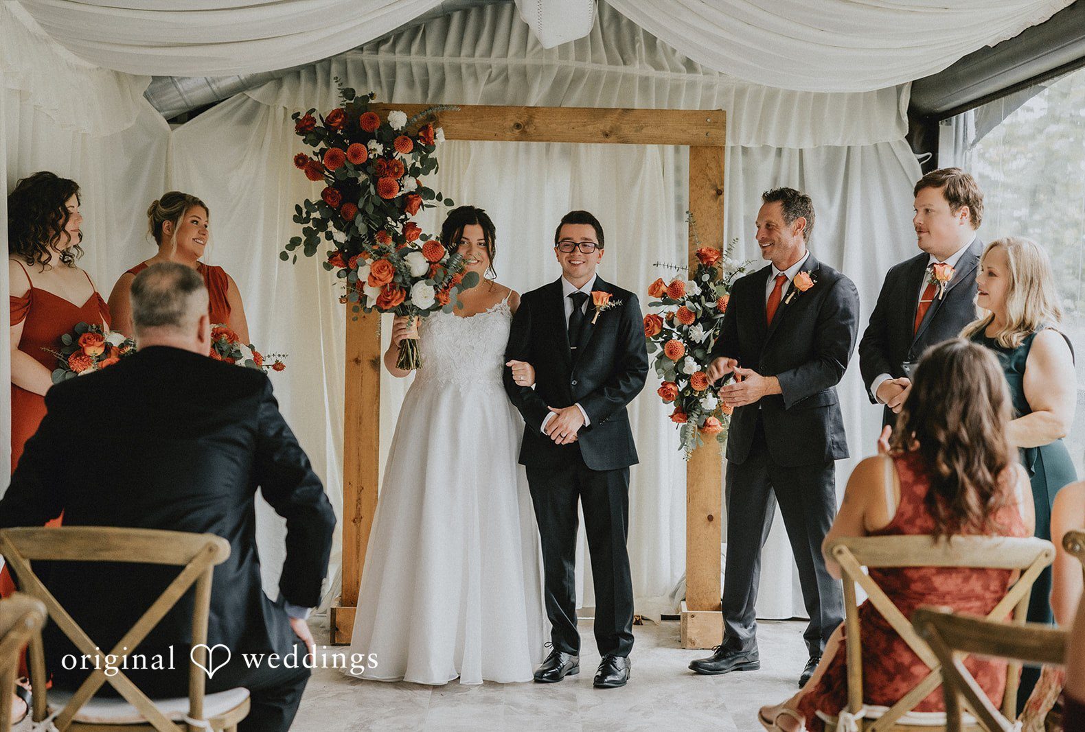 A wide view of a wedding ceremony in progress inside a decorated venue captured by Seattle wedding photographers from Original Weddings at Salish Lodge & Spa.