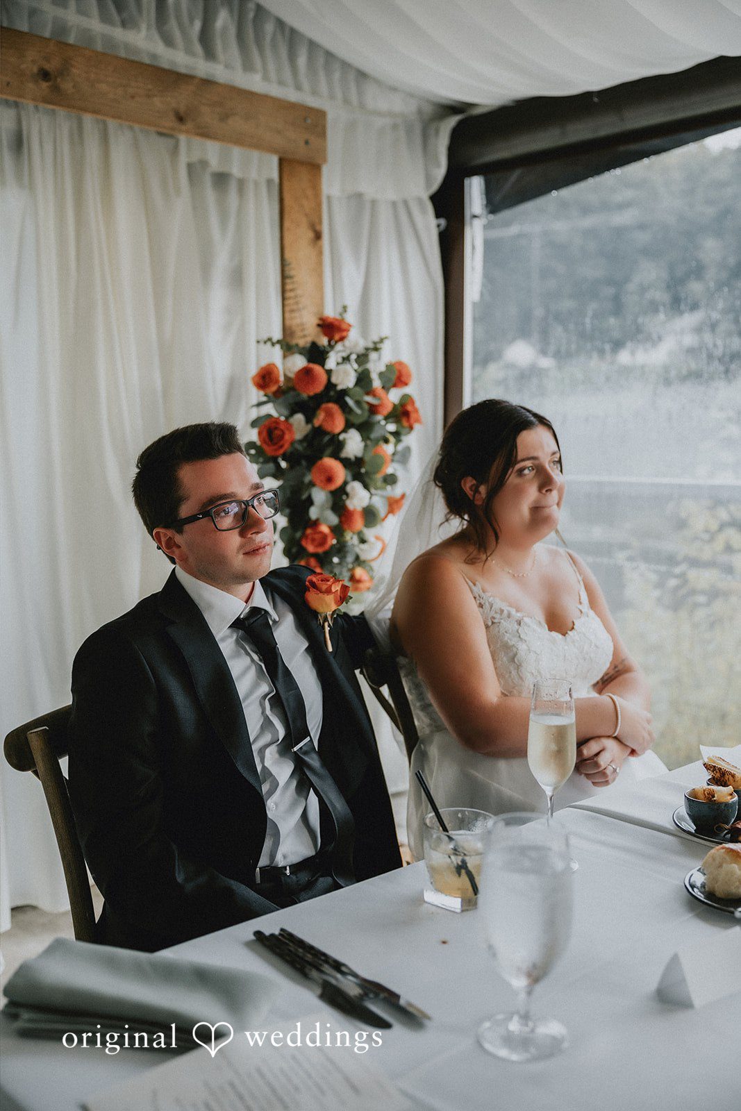 Guests seated at a reception table during a wedding dinner.