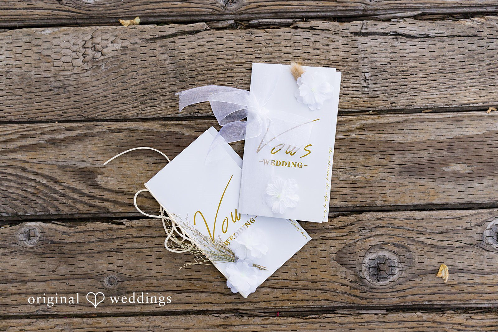 Emily + Paul A wedding invitation suite with custom menus laid out on a rustic wooden surface.