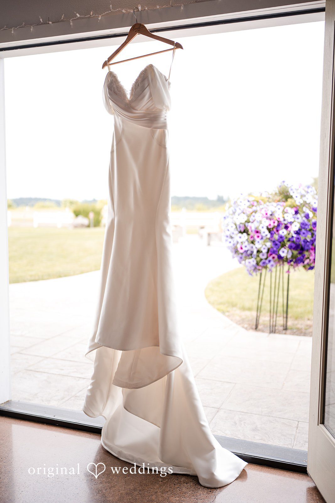 Bridal white wedding dress displayed on the window.