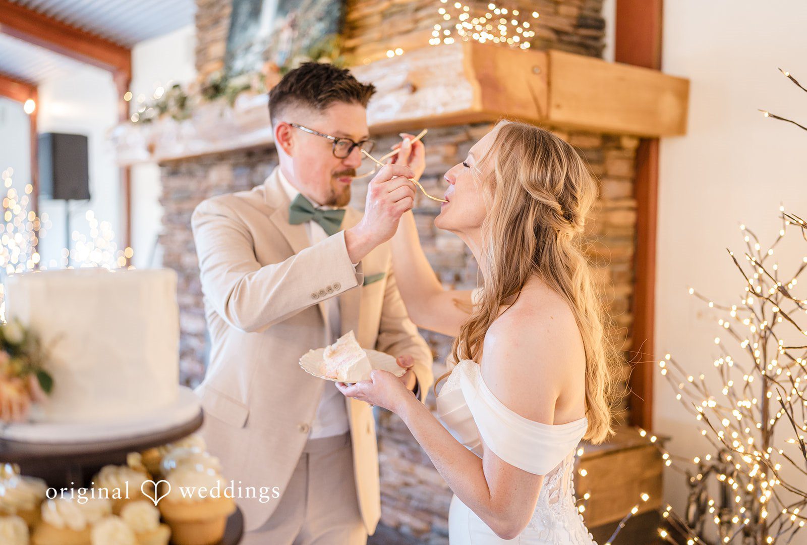 A bride and groom toast each other.