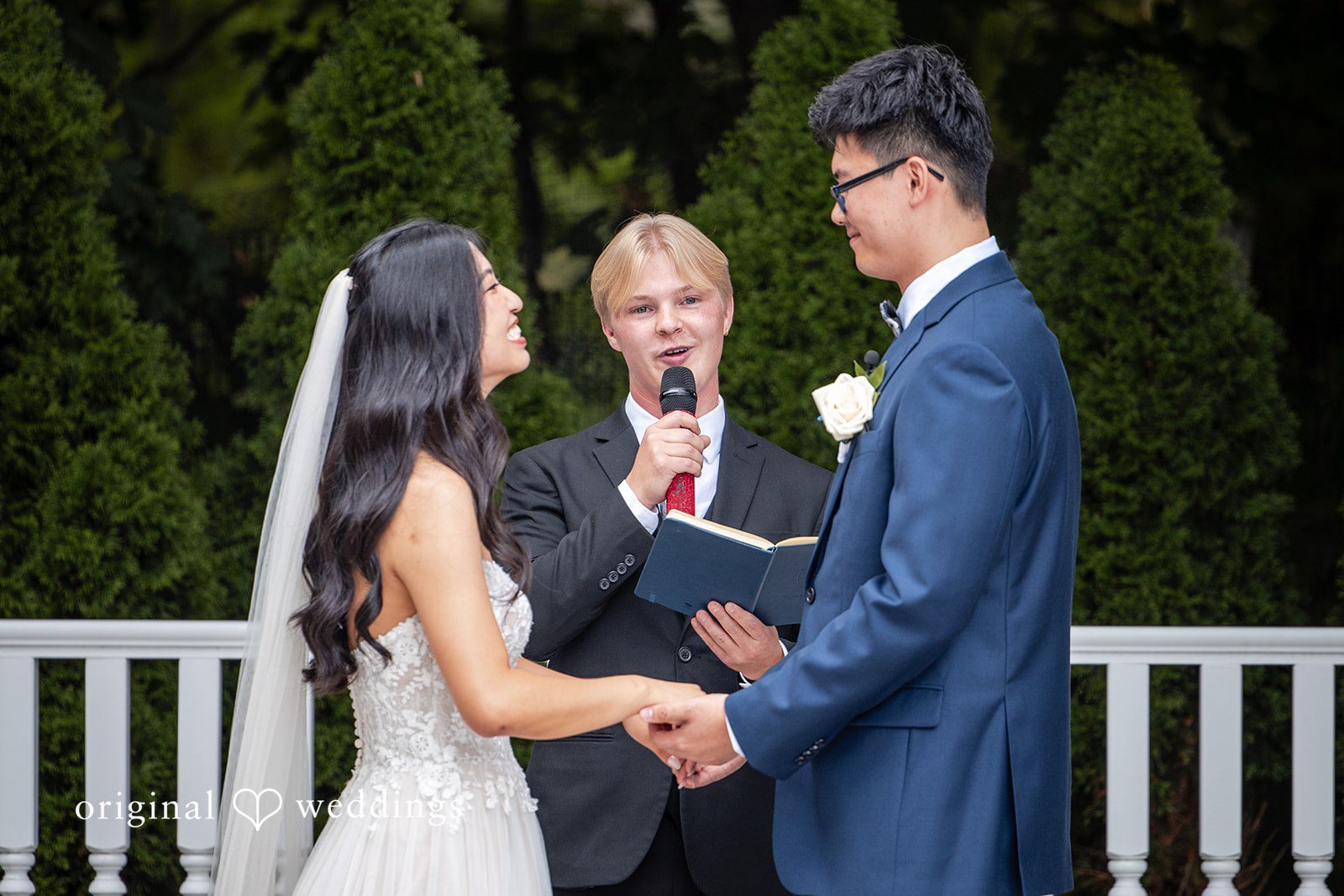 Bride and groom exchanging vows in front of a wedding officiant.