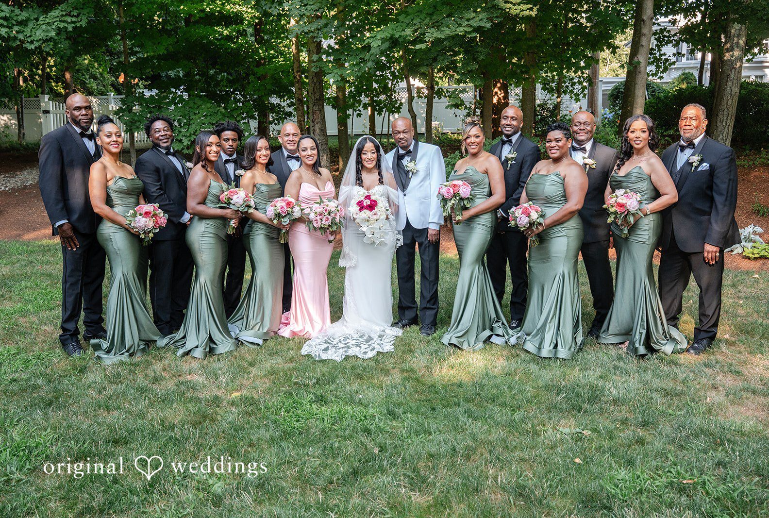 A full wedding party, including bridesmaids and groomsmen, standing together for a group photo at Saphire Estate by Boston Wedding Photographers from Original Weddings.