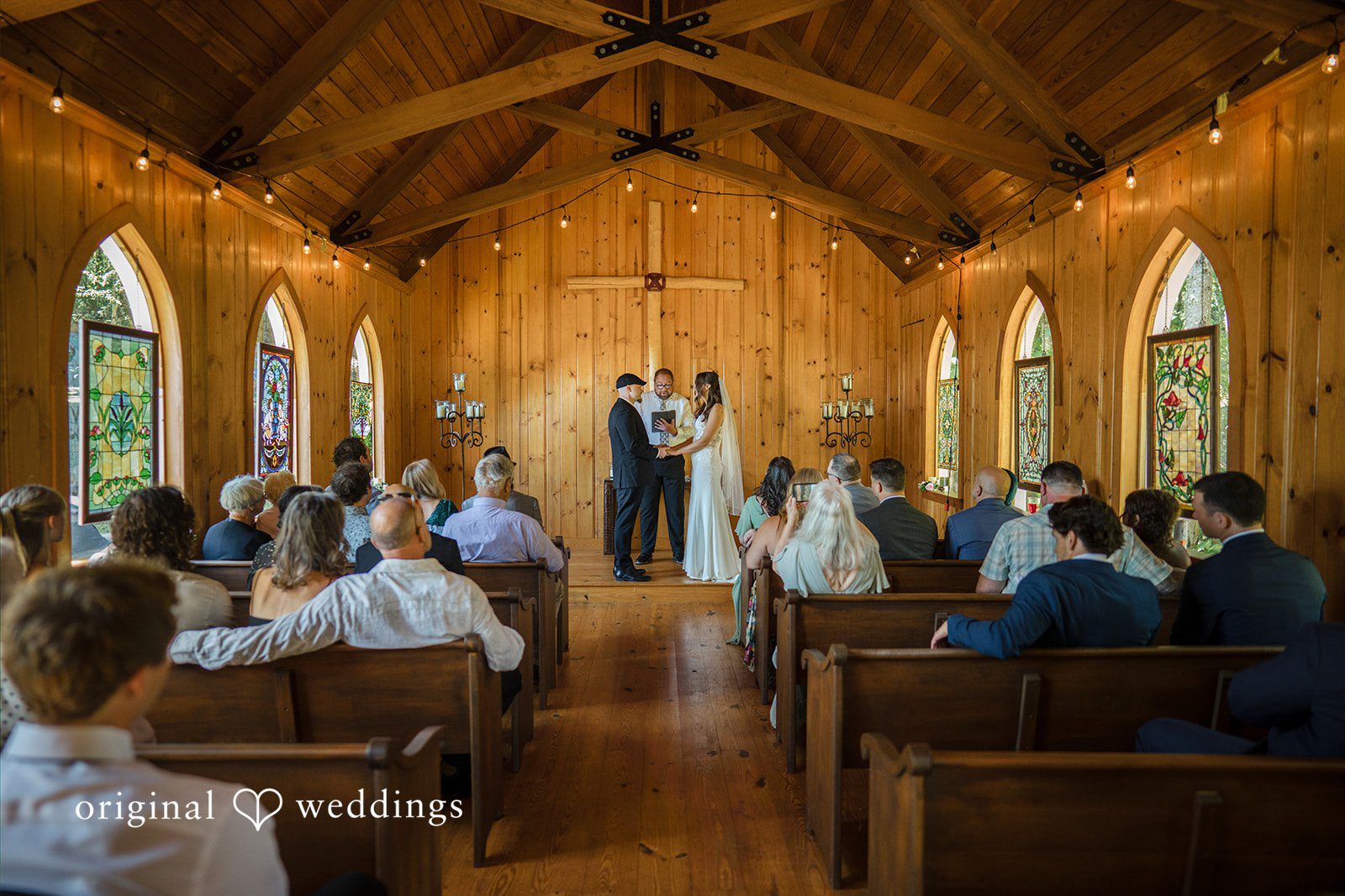 Jade + Nicholas A wedding ceremony viewed from behind the rows of seated guests.