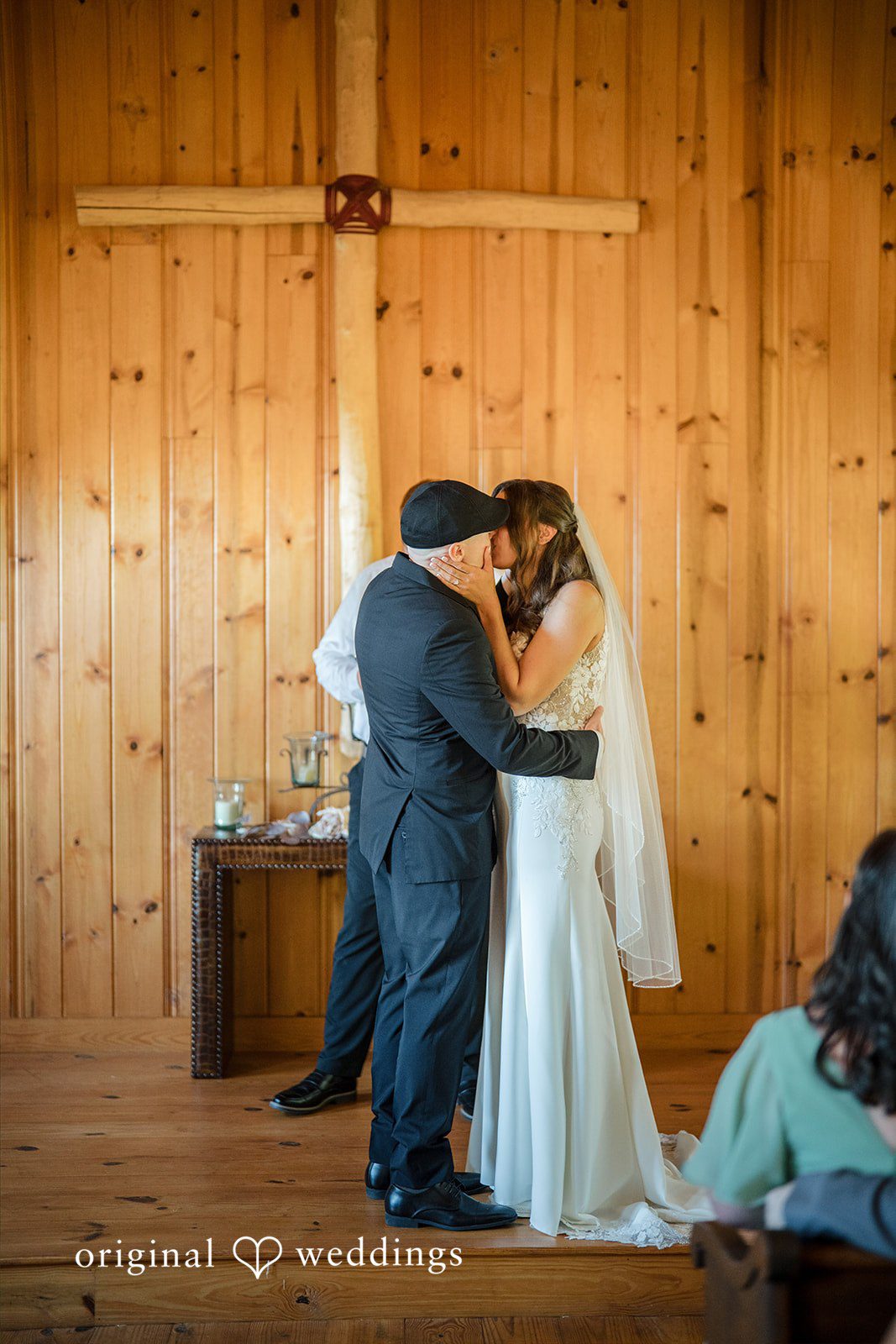Jade + Nicholas A bride and groom embracing at the altar during their ceremony.