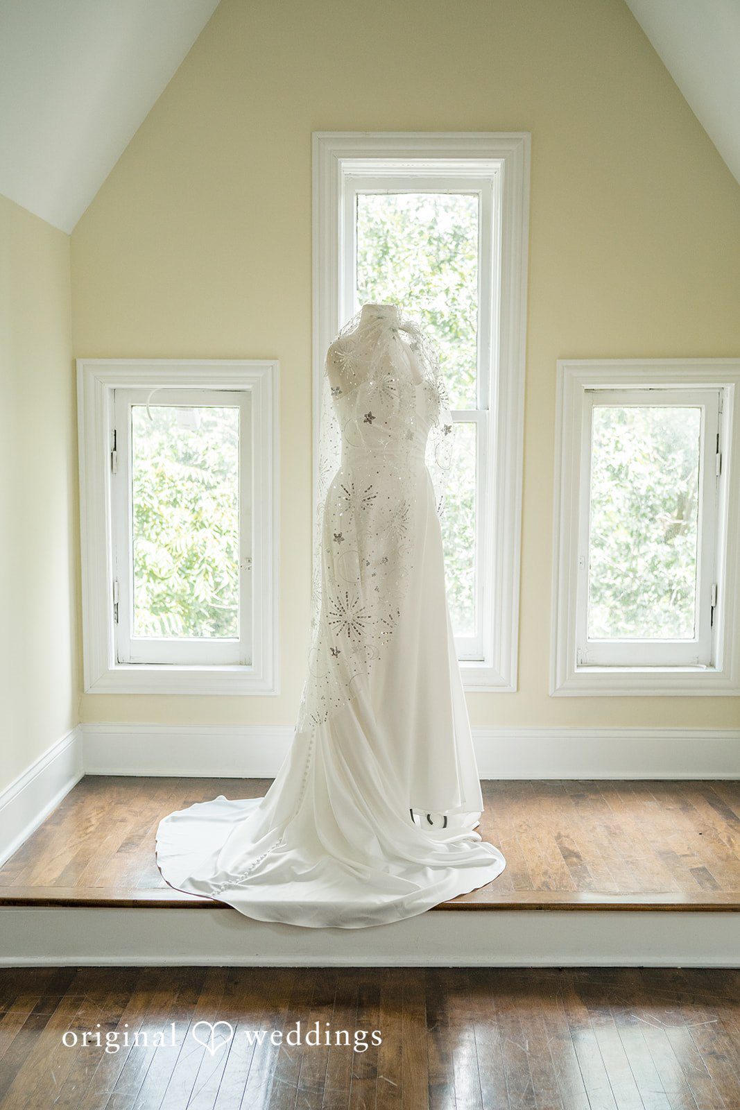 Kimberly + David Detailed white wedding gown displayed on a mannequin.