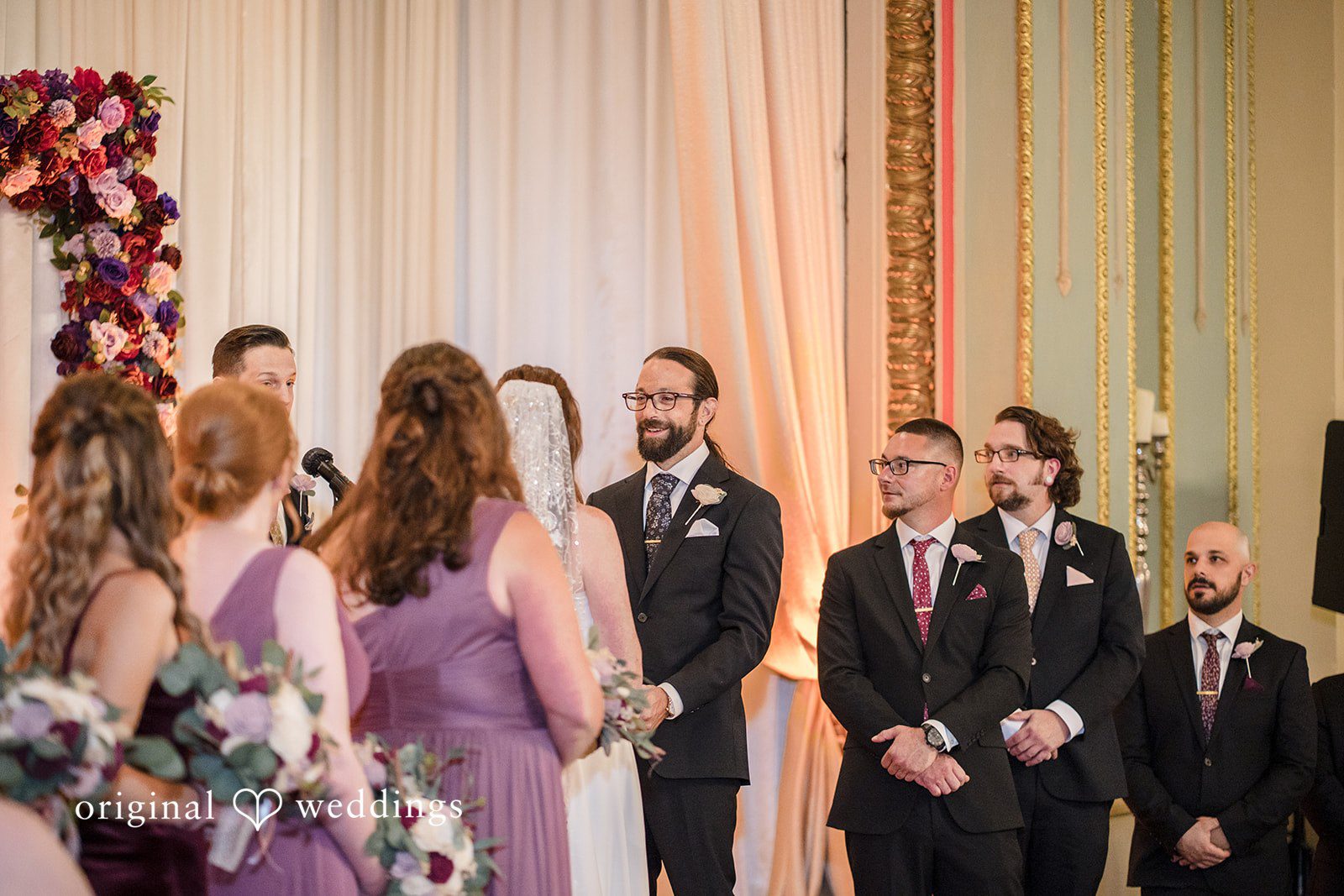 Kimberly + David Bridesmaids and groomsmen standing during the marriage ceremony.