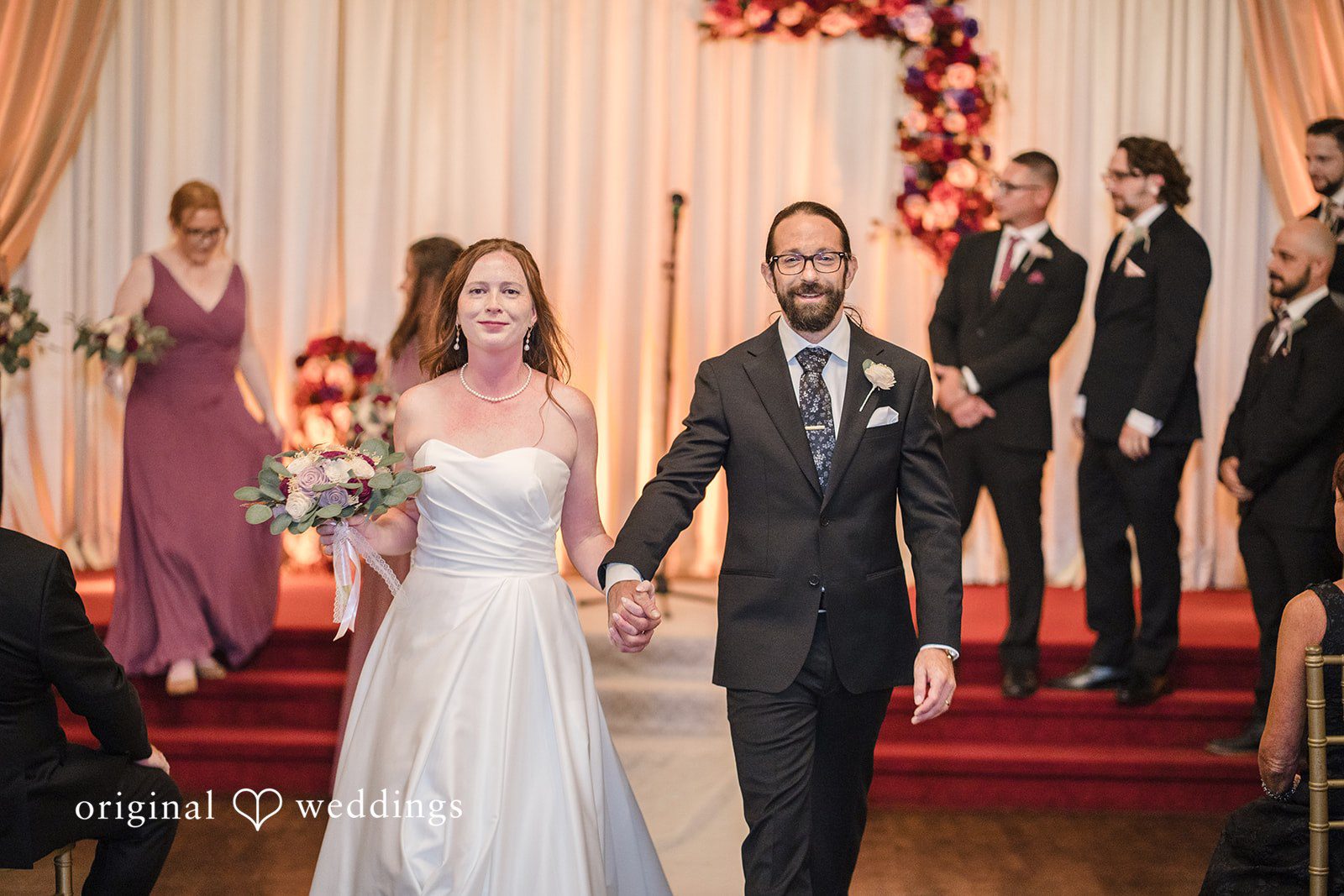 Kimberly + David A bride and groom walking down an aisle aftrer wedding ceremony.