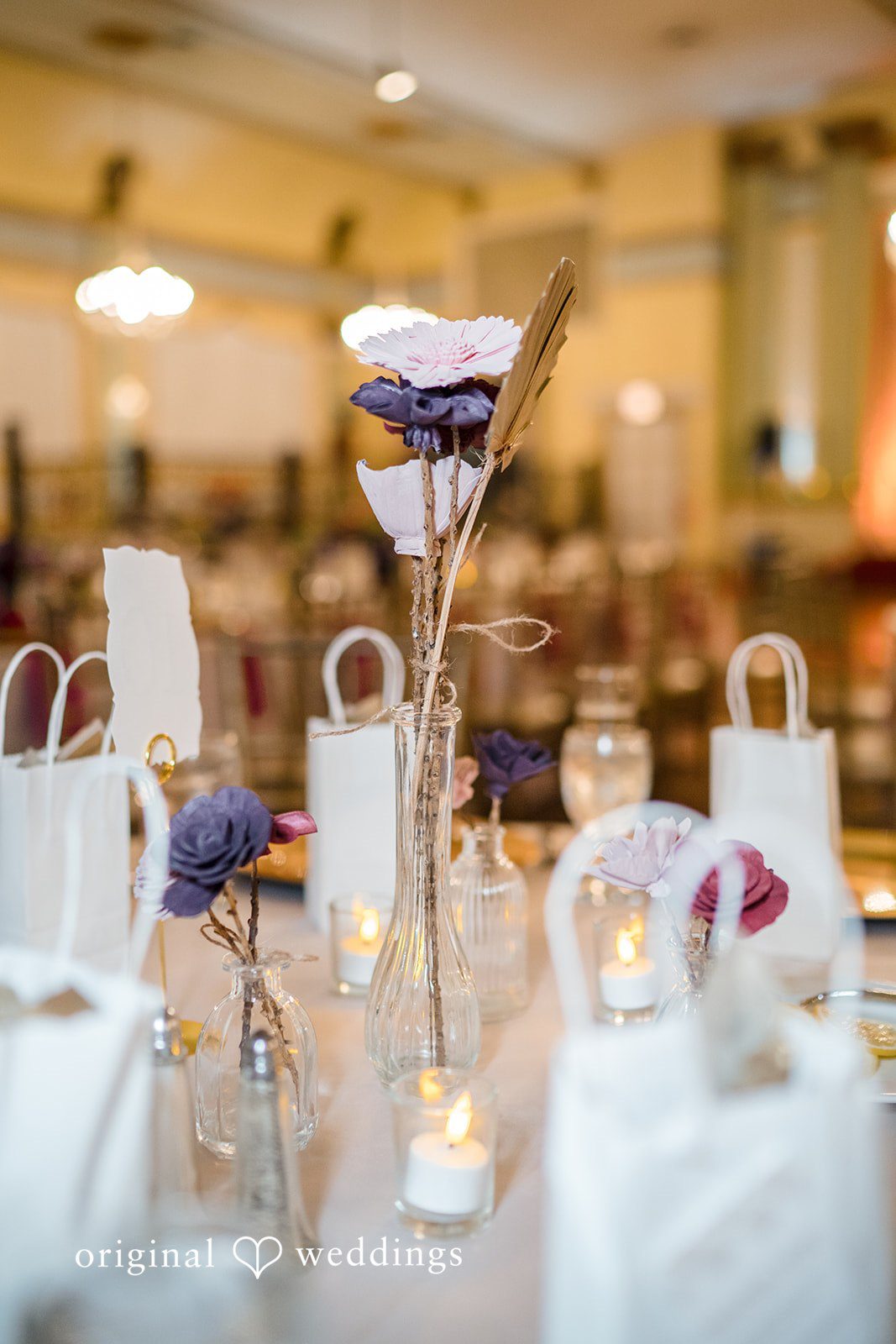 Kimberly + David Elegant reception table arranged with tall candle holders.