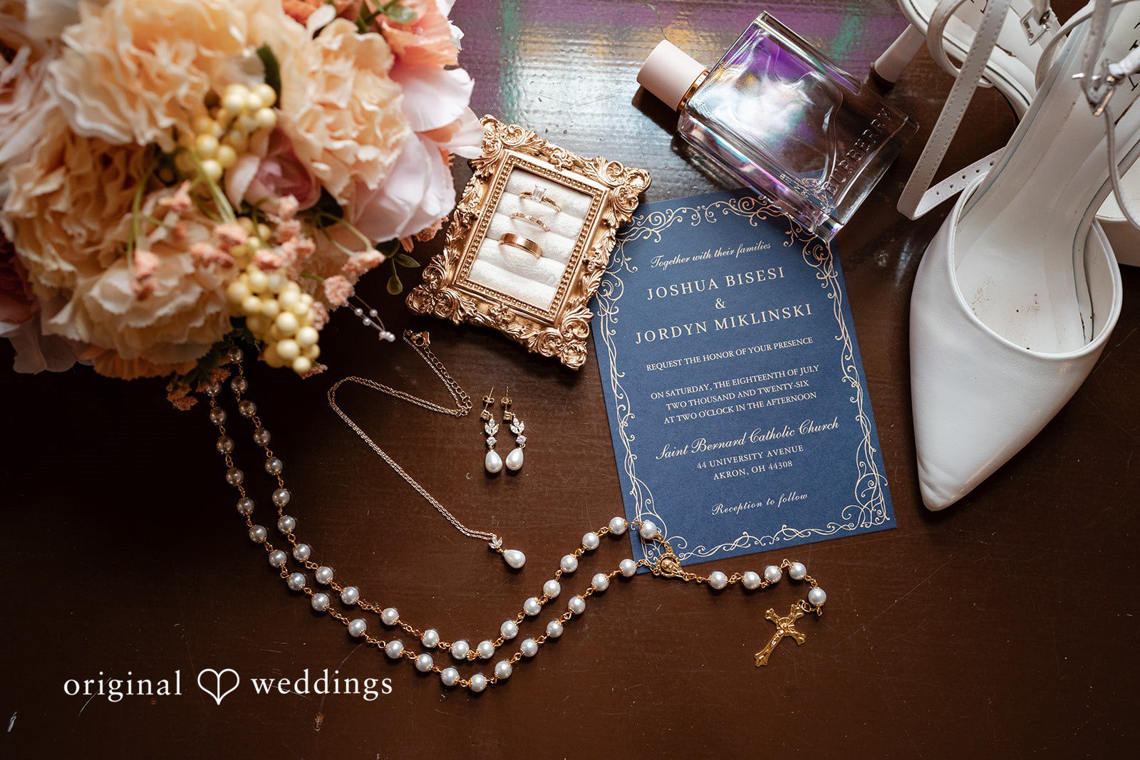 A bridal flat-lay displays wedding shoes, invitation stationery, jewelry, and perfume bottles.