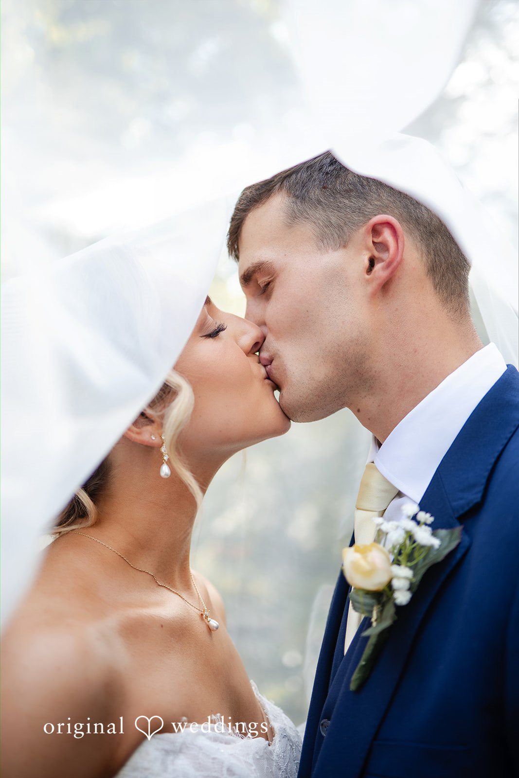 A close-up profile view captures a bride and groom leaning in close to each other.