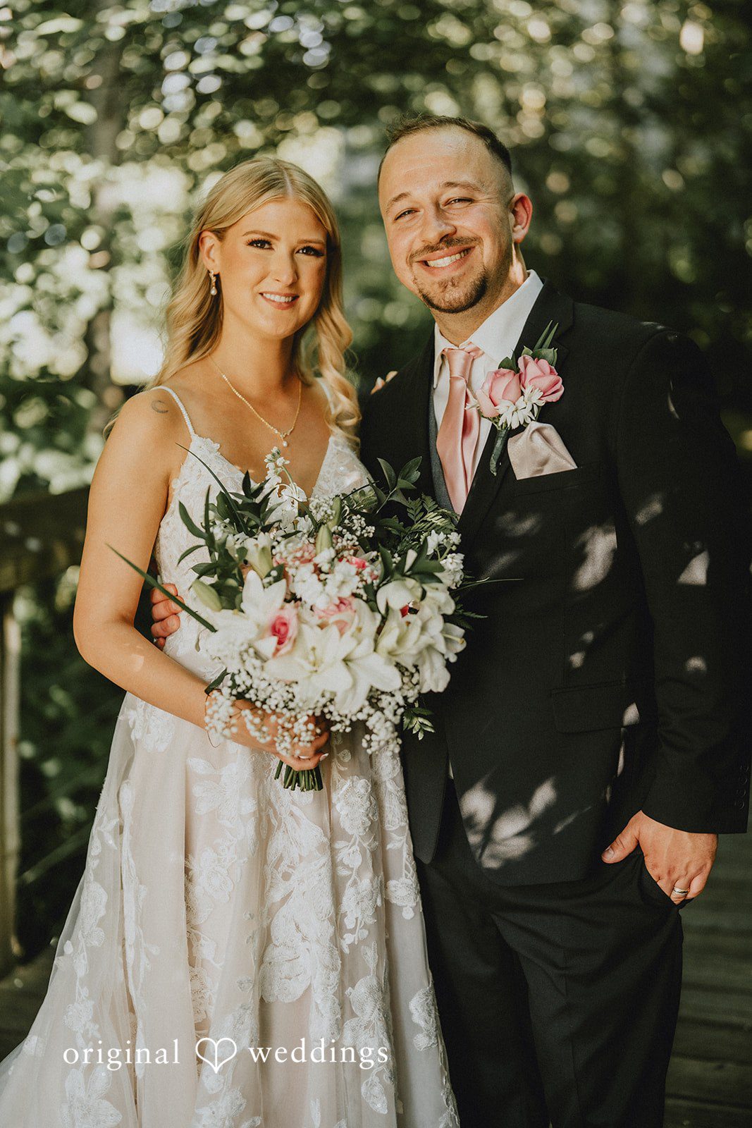 Ashley + Dylan A bride holding a bouquet while standing next to her groom in a black suit.