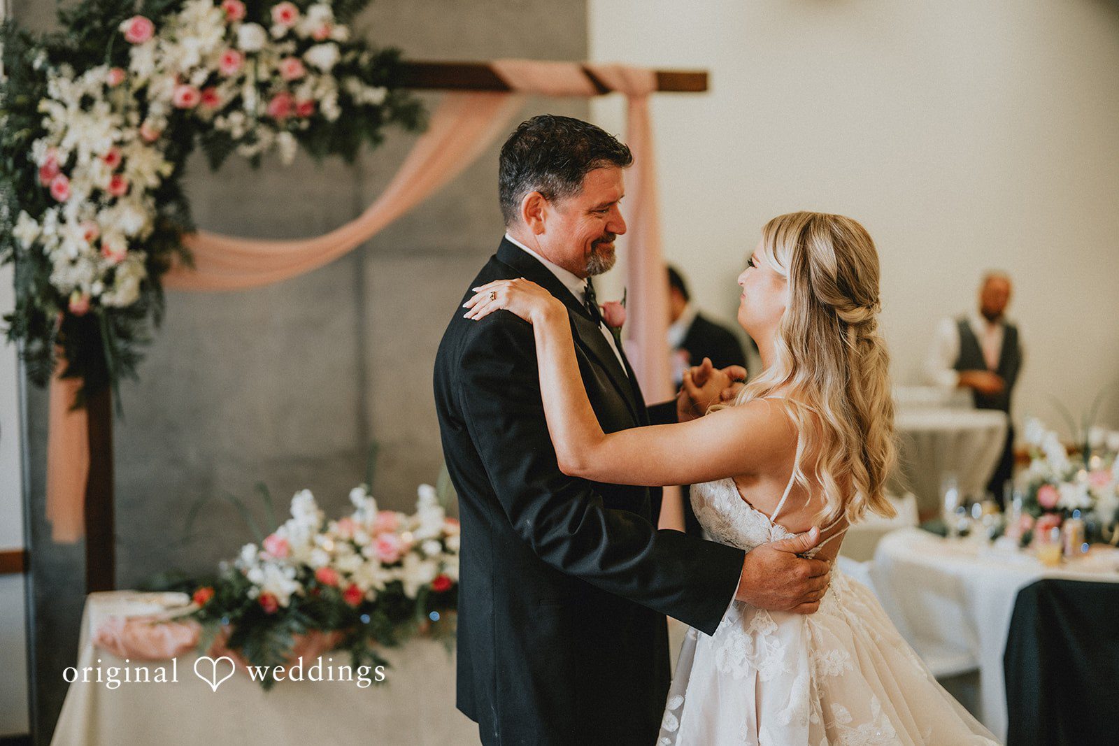 Ashley + Dylan A bride and man facing each other lovingly during the reception celebration.