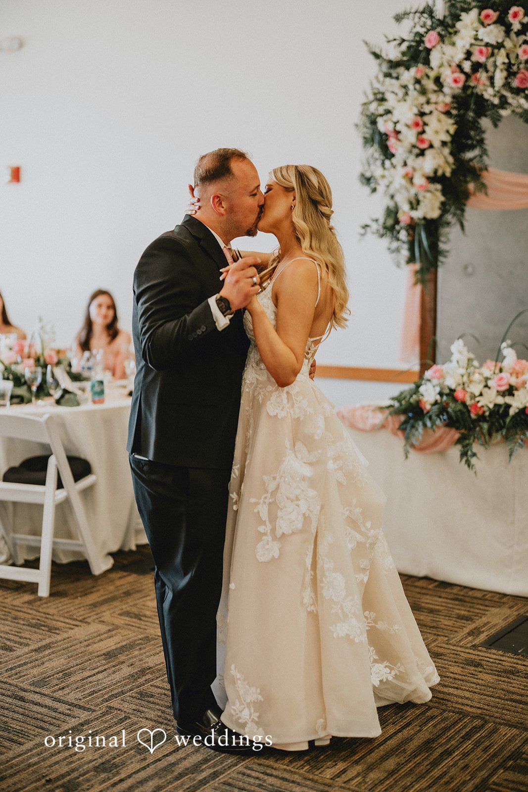 Ashley + Dylan A bride and groom sharing their first dance together on the reception dance floor.