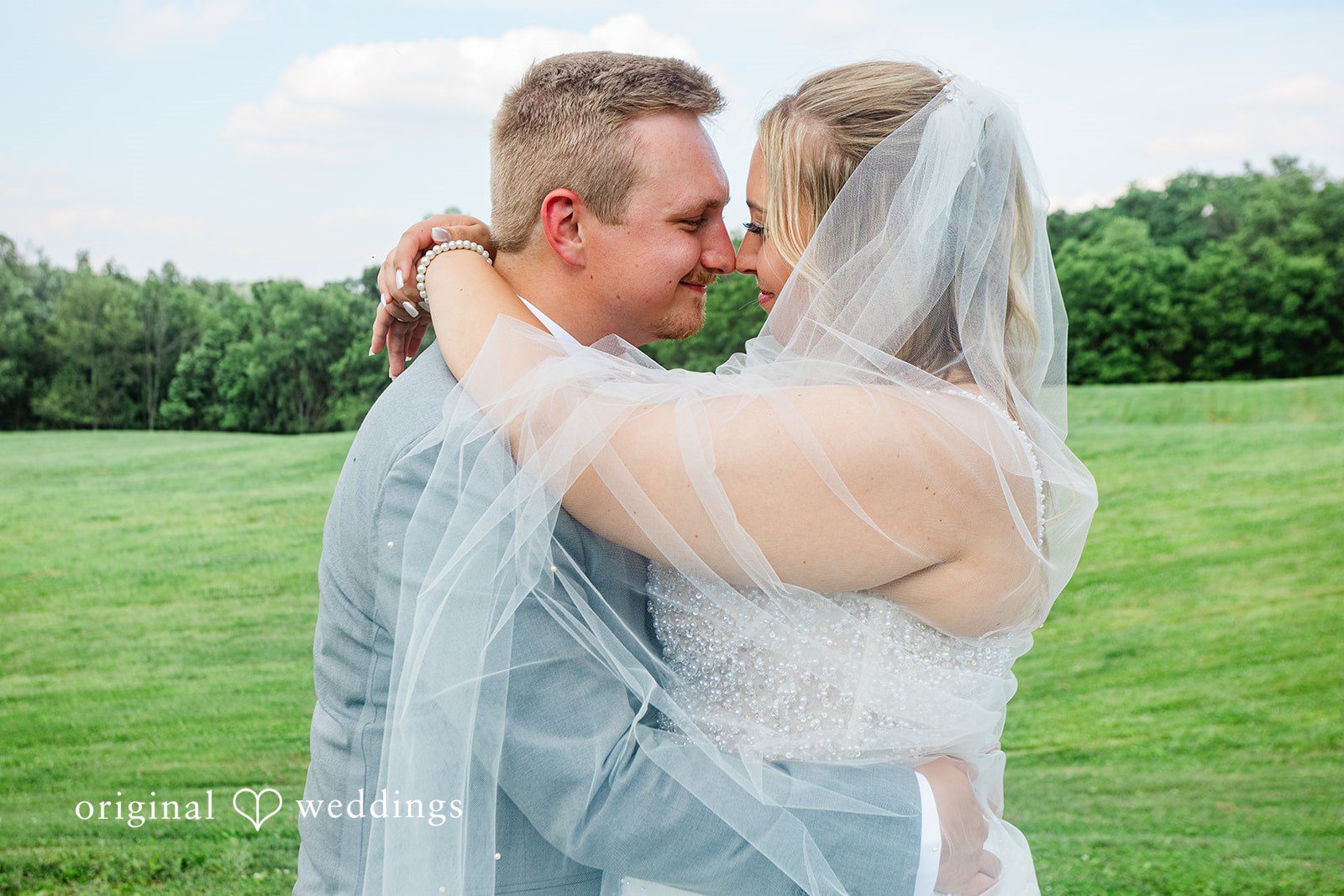 A bride and groom hugging closely at The Farm Event Center.