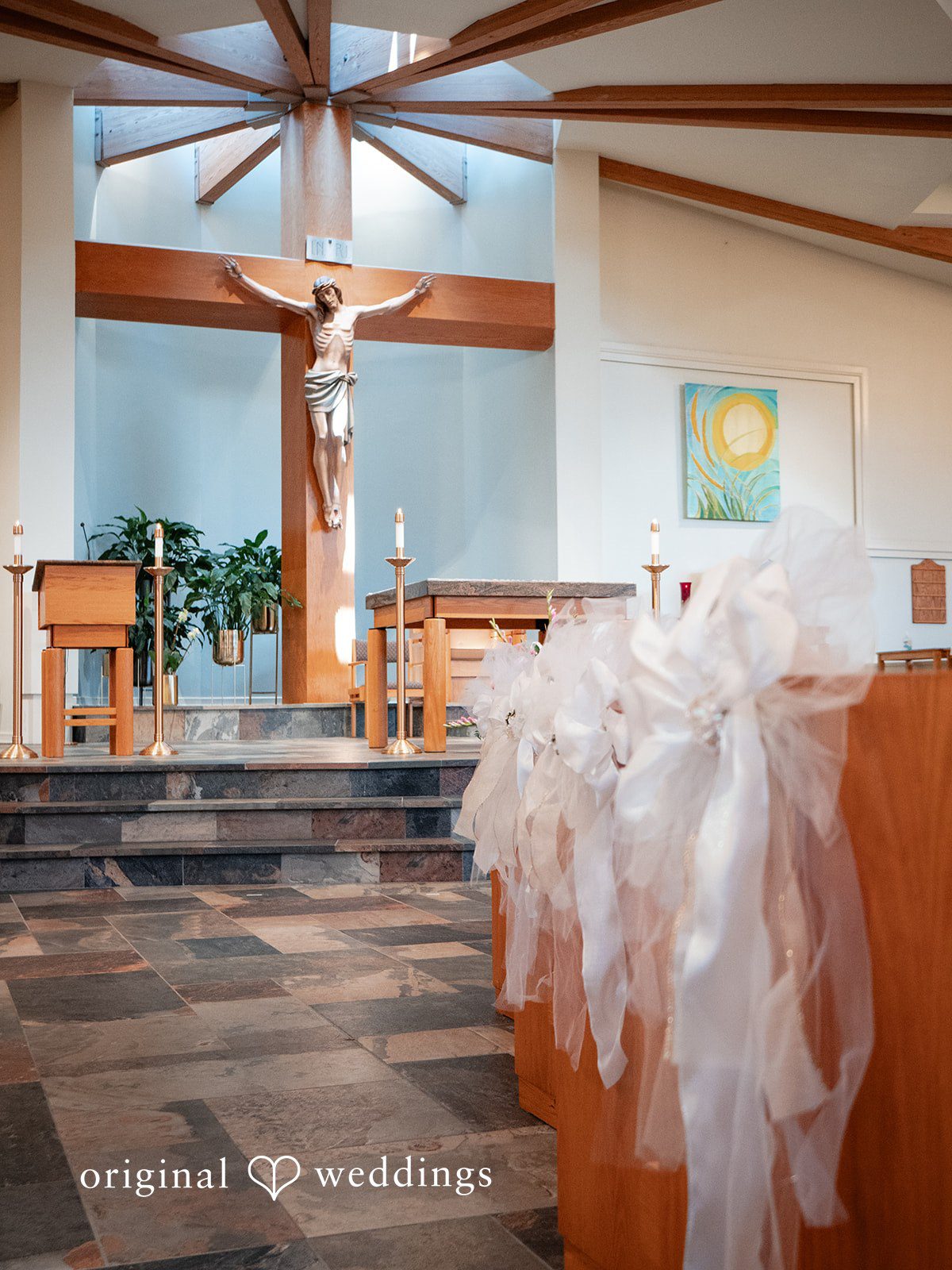 Vincenzo + Kristin A wedding reception table decorated with sheer white tulle fabric.