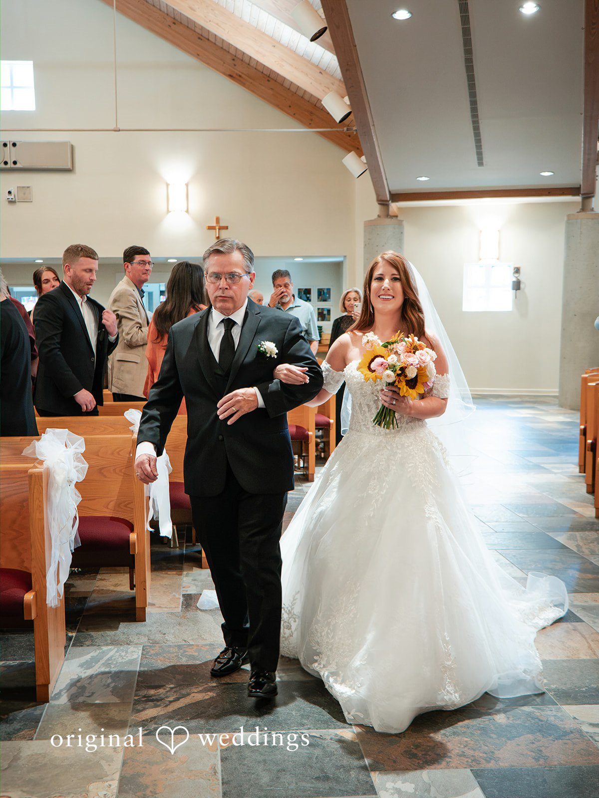 Vincenzo + Kristin A bride and man walking down the aisle together.