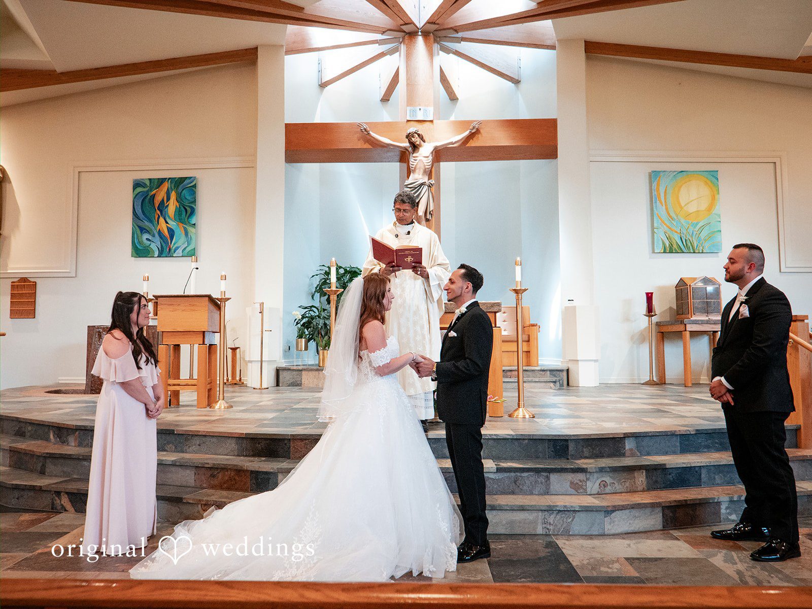 Vincenzo + Kristin A bride and groom interacting near the altar during their wedding ceremony.