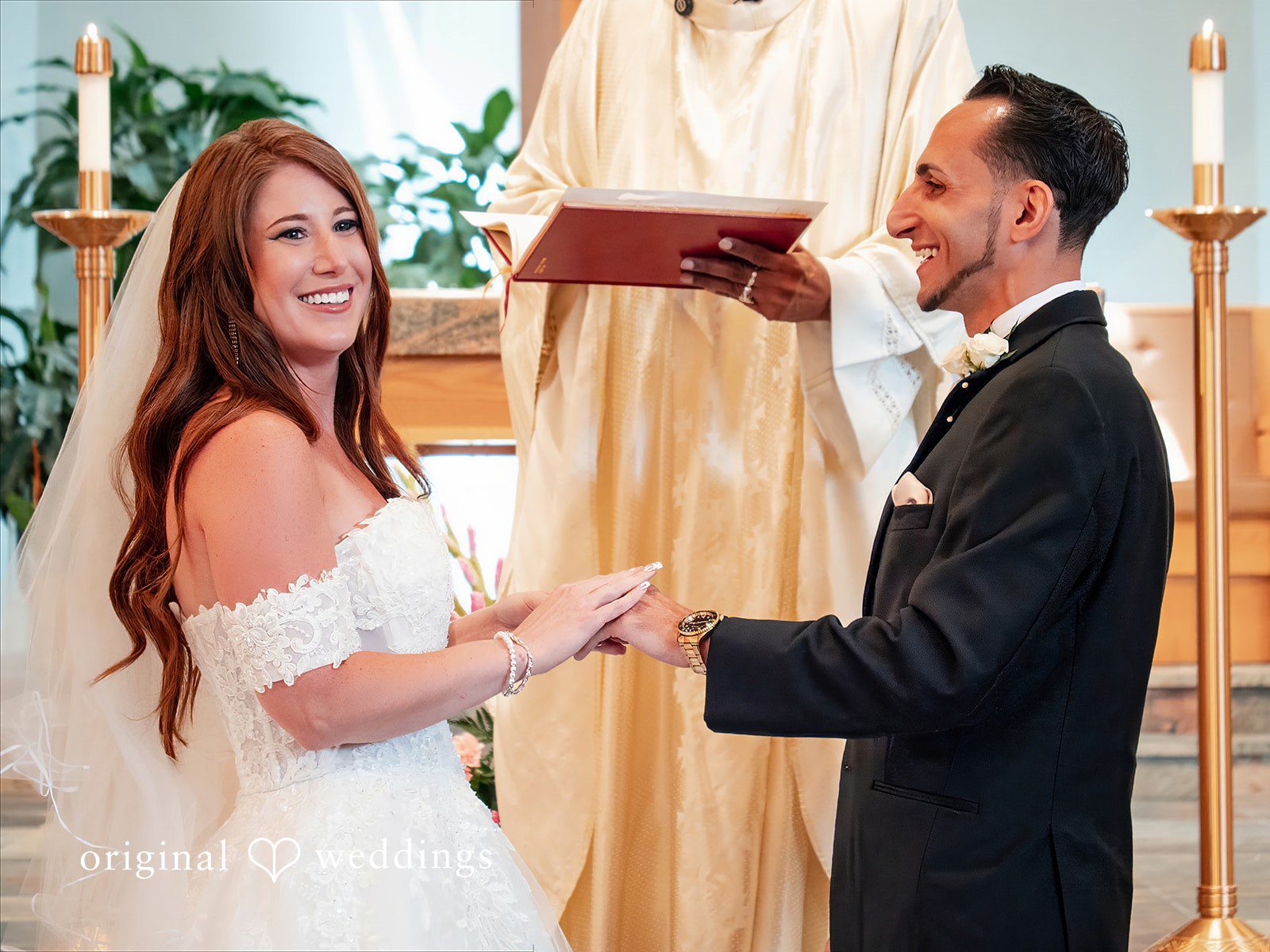 July 11, 2026 – Vincenzo & Kristin – (ID-4669) REVISED 9.6 A bride in a white gown standing next to her groom in a black suit.