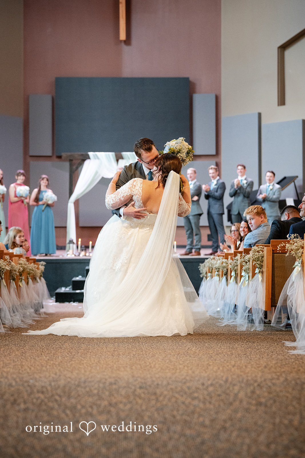 Emma + Aidan A bride and groom sharing their first kiss after their ceremony.