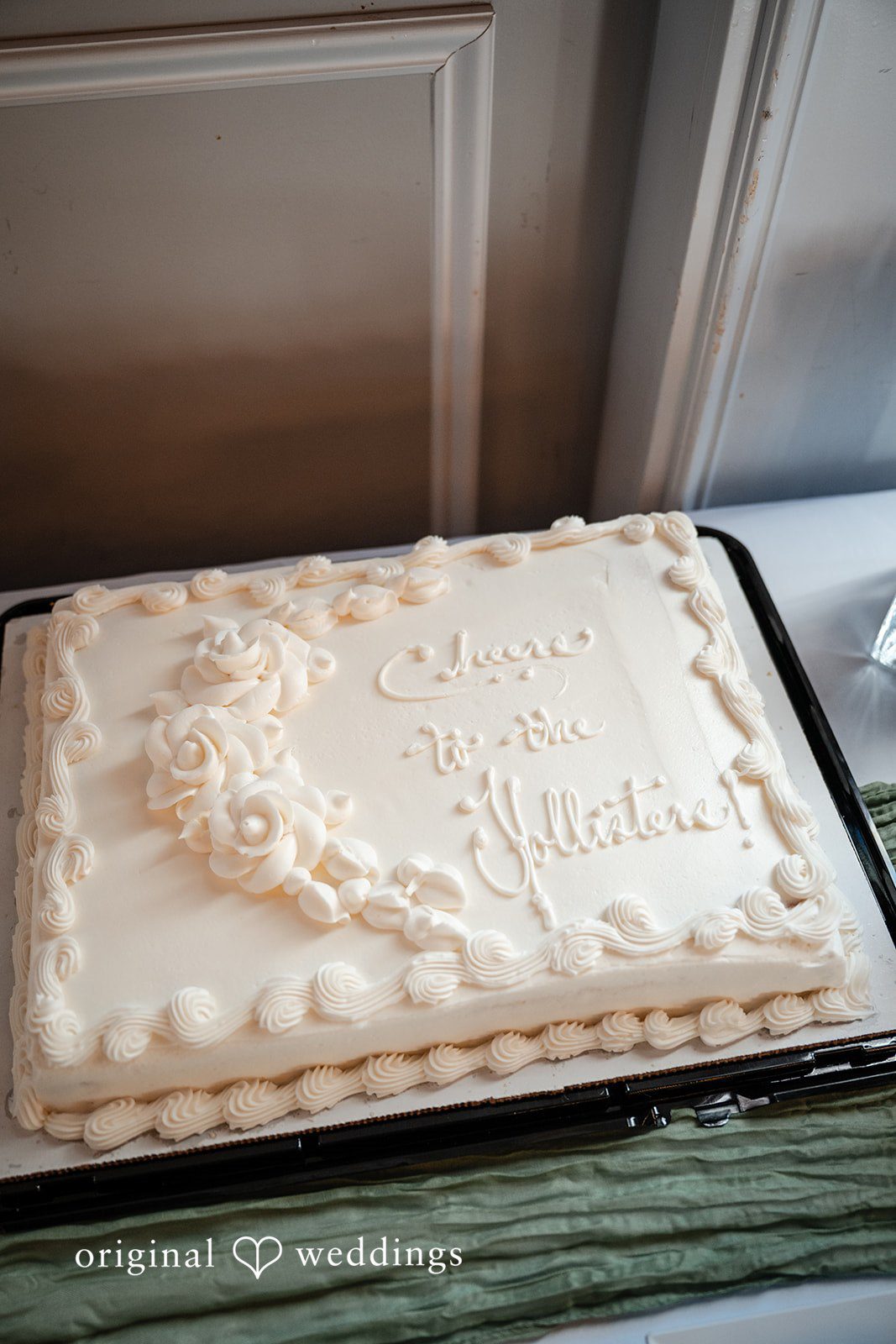 Emma + Aidan A large, rectangular sheet cake decorated with white frosting patterns.