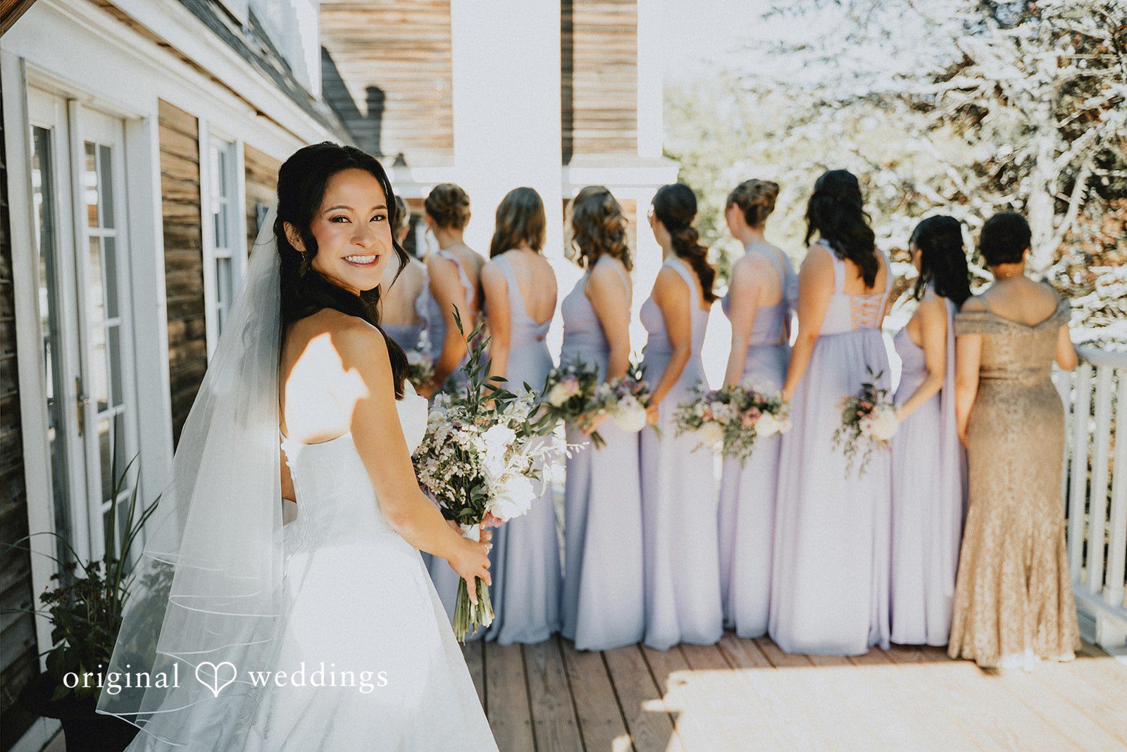 Bride standing next to her bridesmaids in matching dresses.