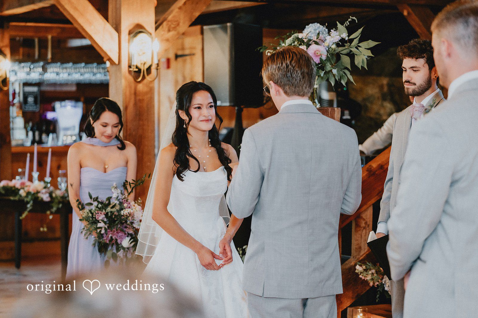 Bride and groom standing at the altar facing a wedding officiant.