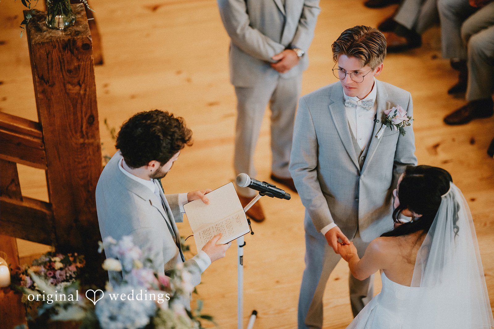 Bride and groom holding hands during their wedding ceremony.