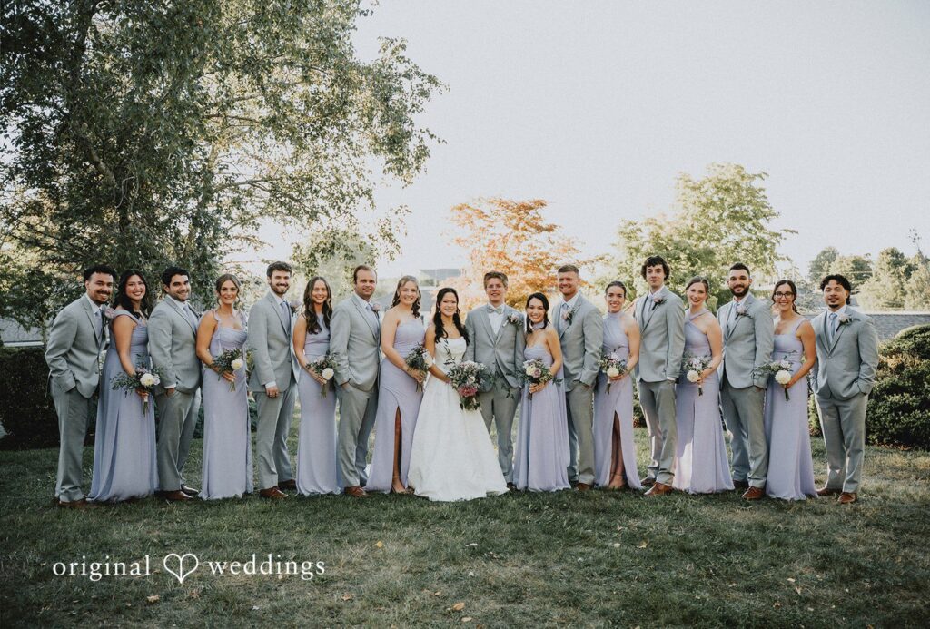 Andrew + Parousia Full bridal party of bridesmaids and groomsmen standing together in a long line at The Red Lion Inn by Boston Wedding Photographers from Original Weddings..