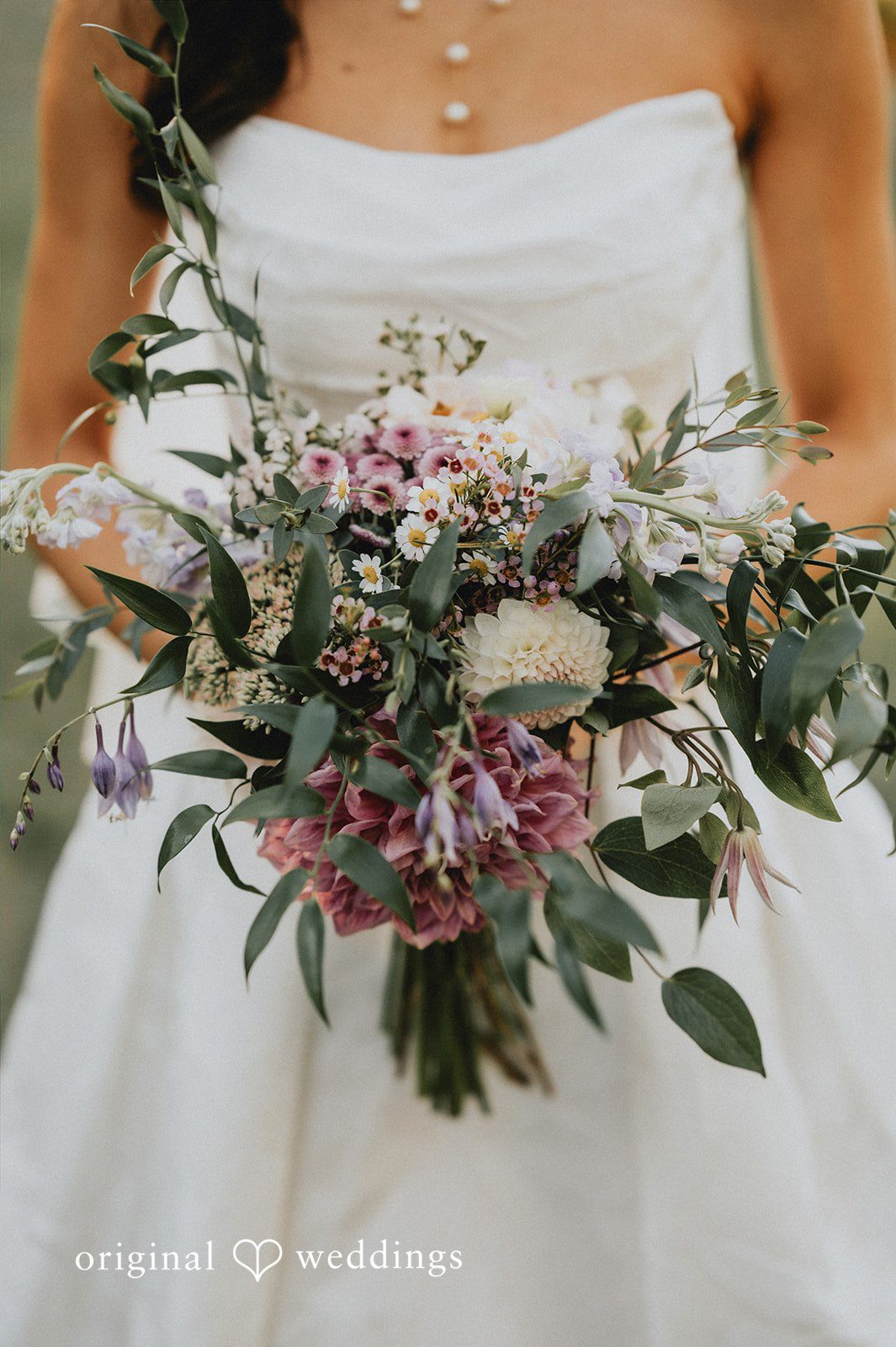 Close-up of a bridal bouquet with white flowers and eucalyptus.