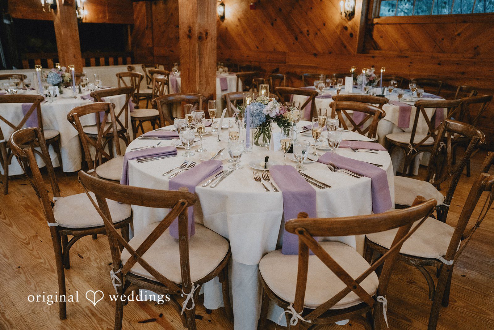 Elegant round banquet table set with white linens.
