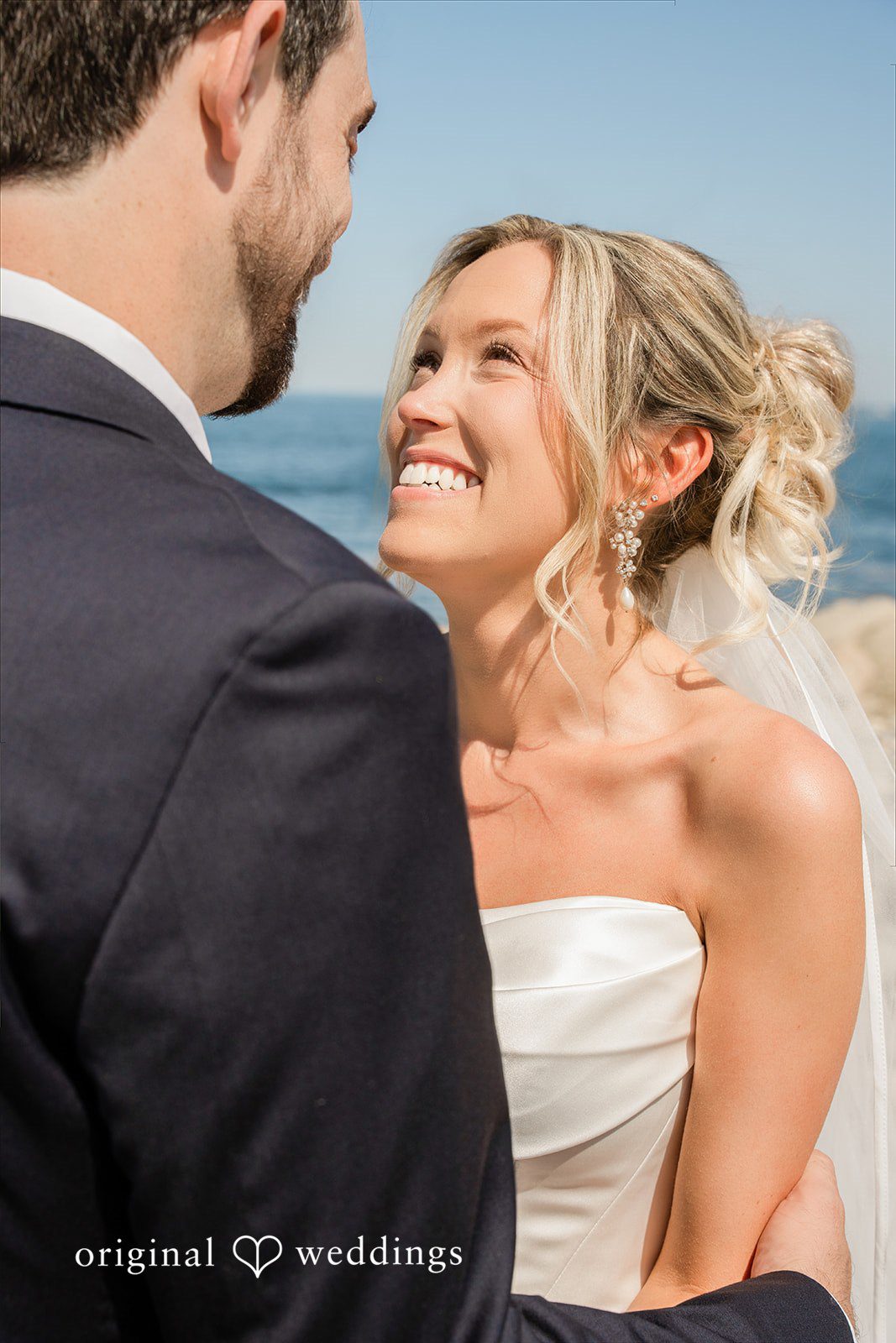 Jessica + Keegan A groom looking lovingly at his smiling bride during a close-up portrait session.