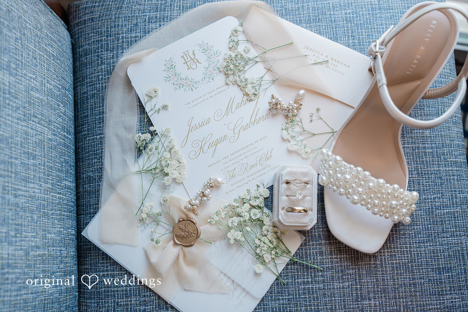 Jessica + Keegan A close-up view of a bride's embroidered veil resting alongside a detailed lace wedding shoe.