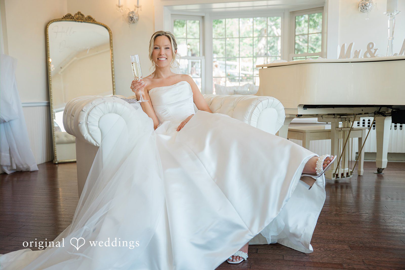 Jessica + Keegan A bride in a full ballgown wedding dress sitting on the floor as the skirt plumes around her.