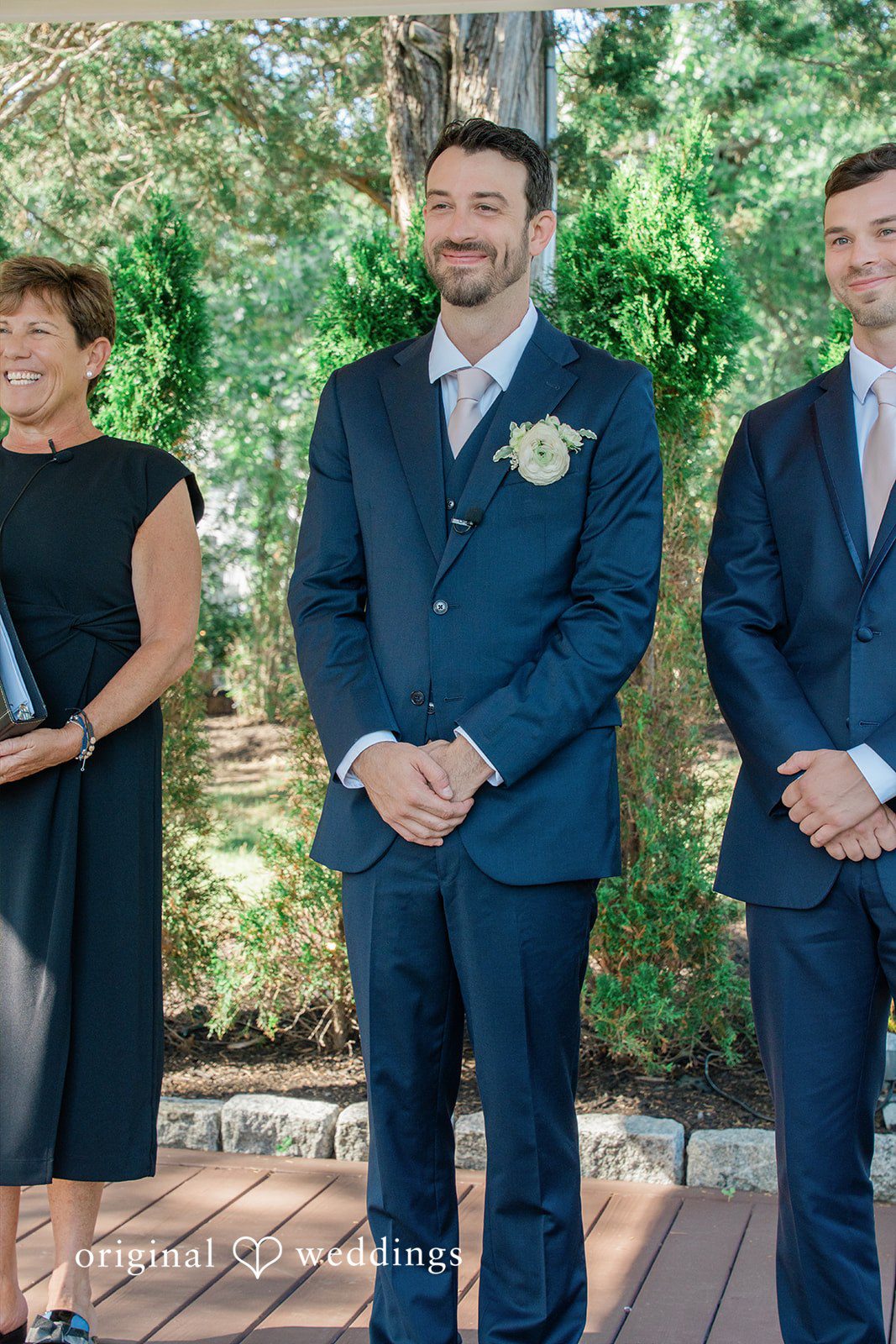 Jessica + Keegan A groom standing at the altar alongside his groomsmen during the ceremony.