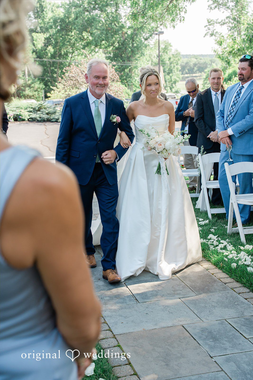 Jessica + Keegan A bride walking down the aisle with the man toward the altar.