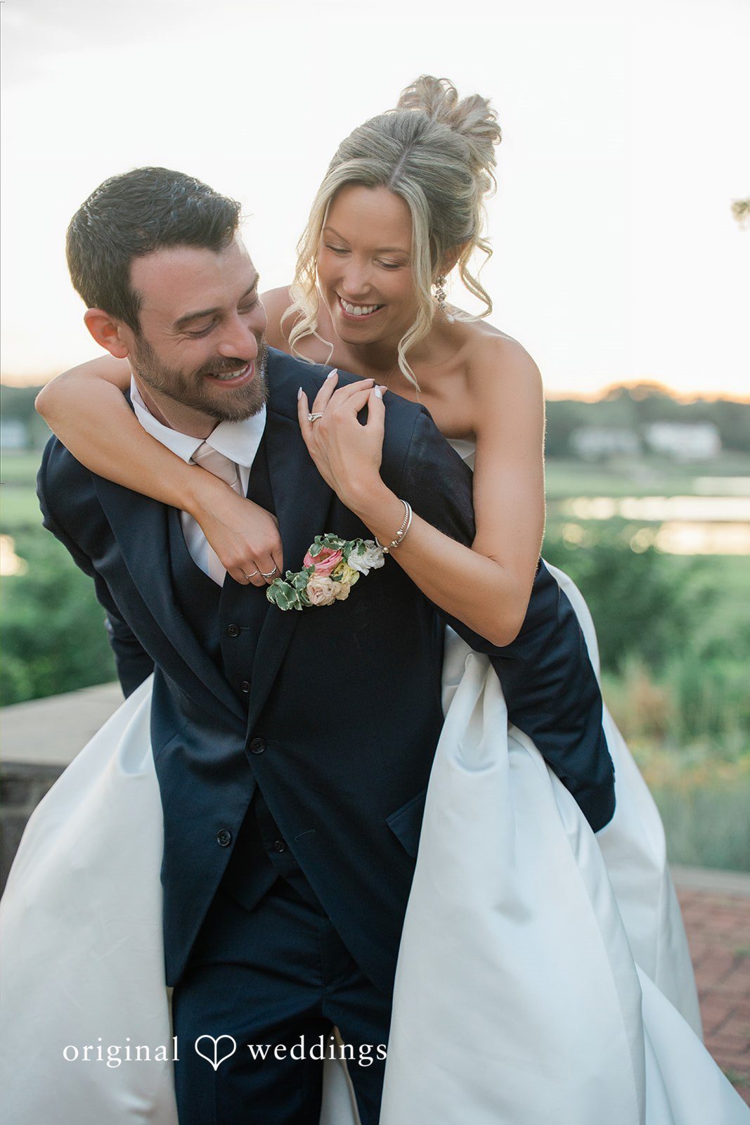 Jessica + Keegan A bride and groom hugging tightly and smiling during a portrait session.