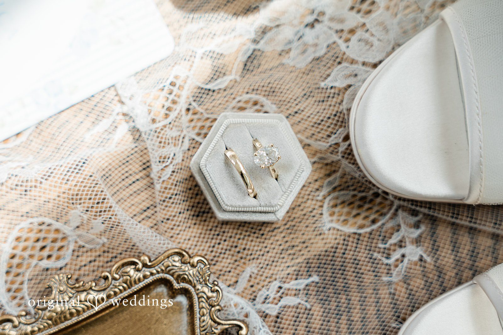 Veronica + Wyatt A flat lay of wedding details including a small decorative tray on a wooden surface.