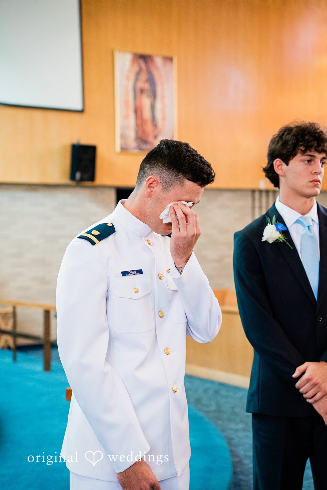Veronica + Wyatt A groom in a white uniform looking emotional alongside his groomsman.