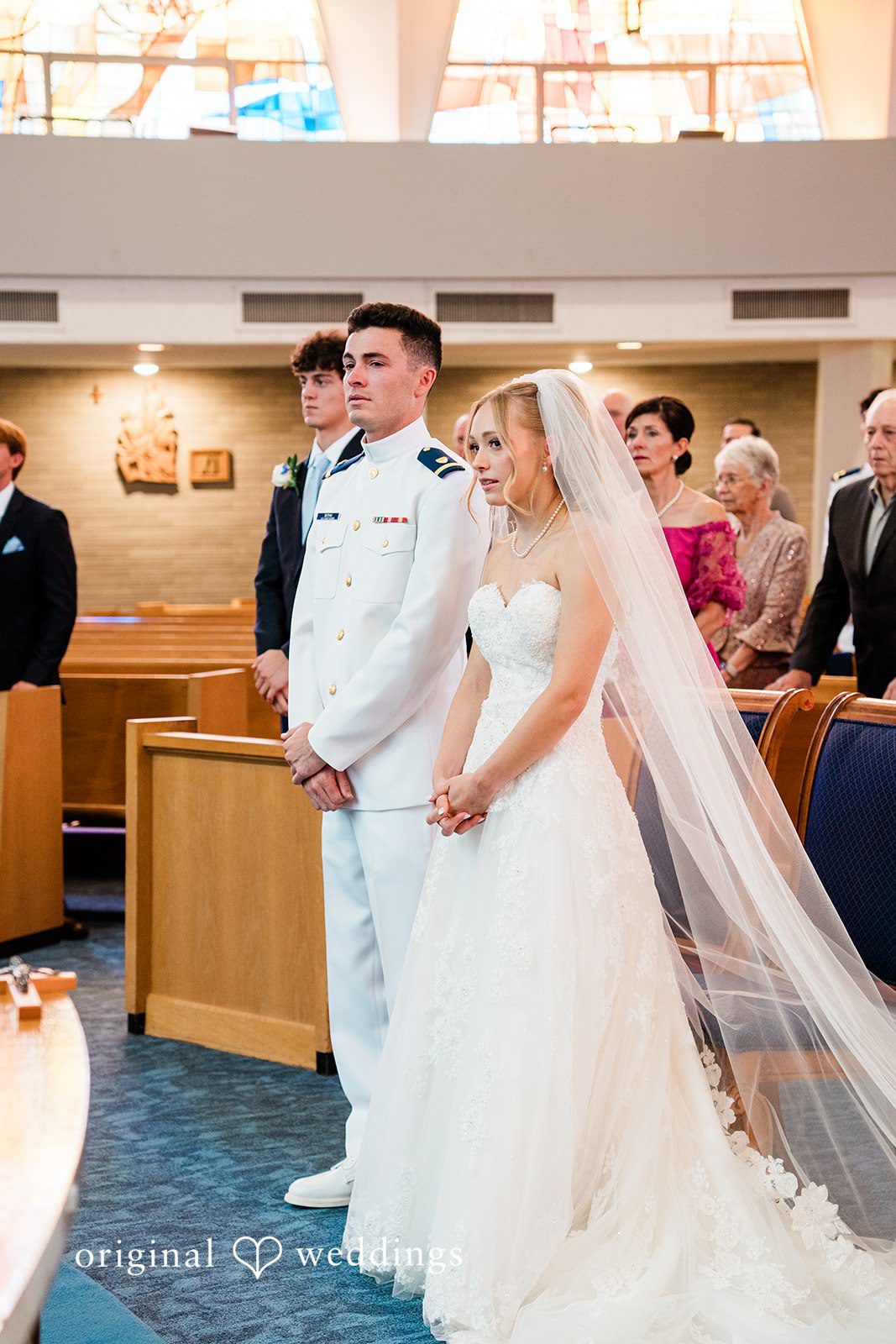 Veronica + Wyatt A bride and groom standing at the altar during a church ceremony.