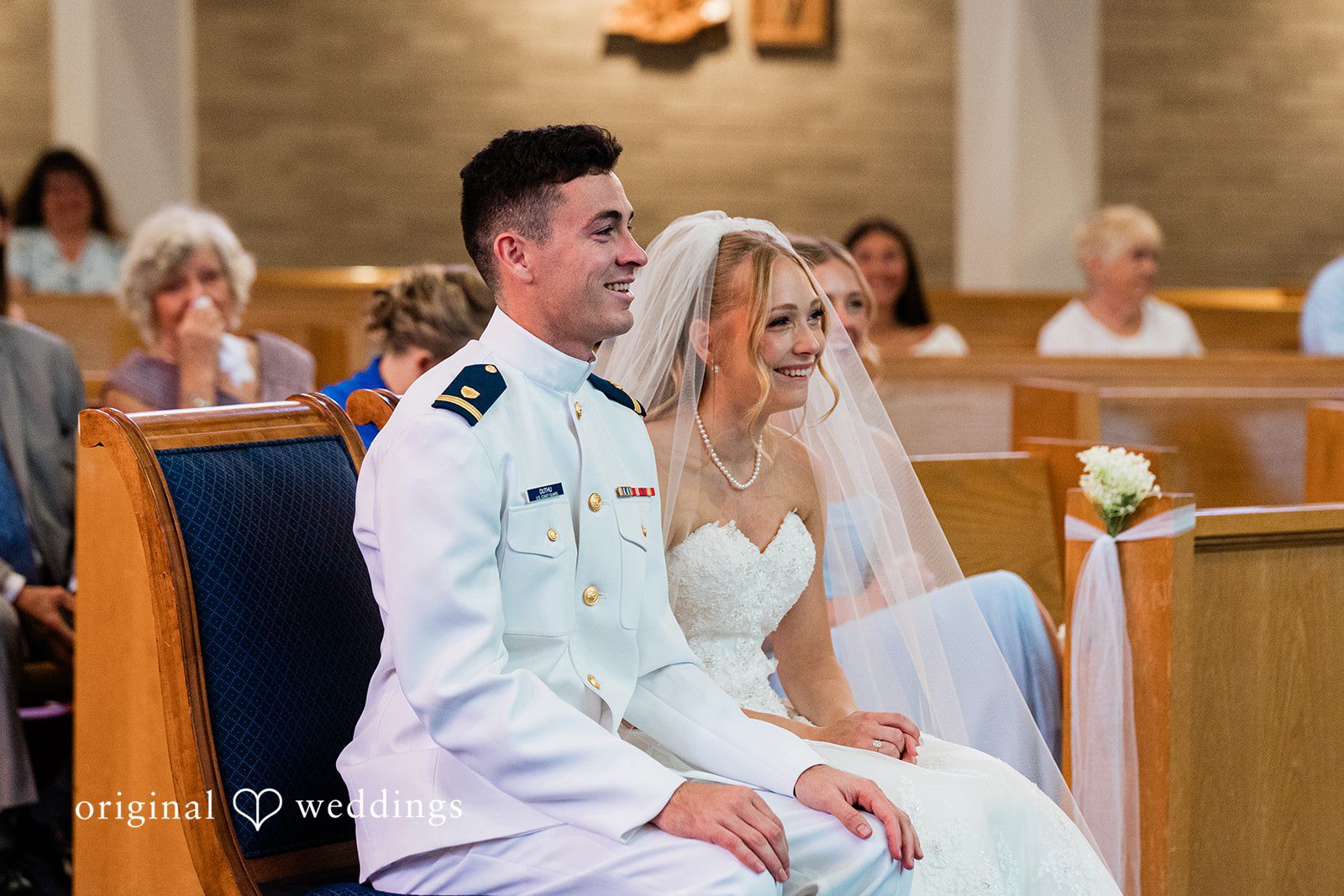 Veronica + Wyatt A bride and groom kneeling together at the church altar.