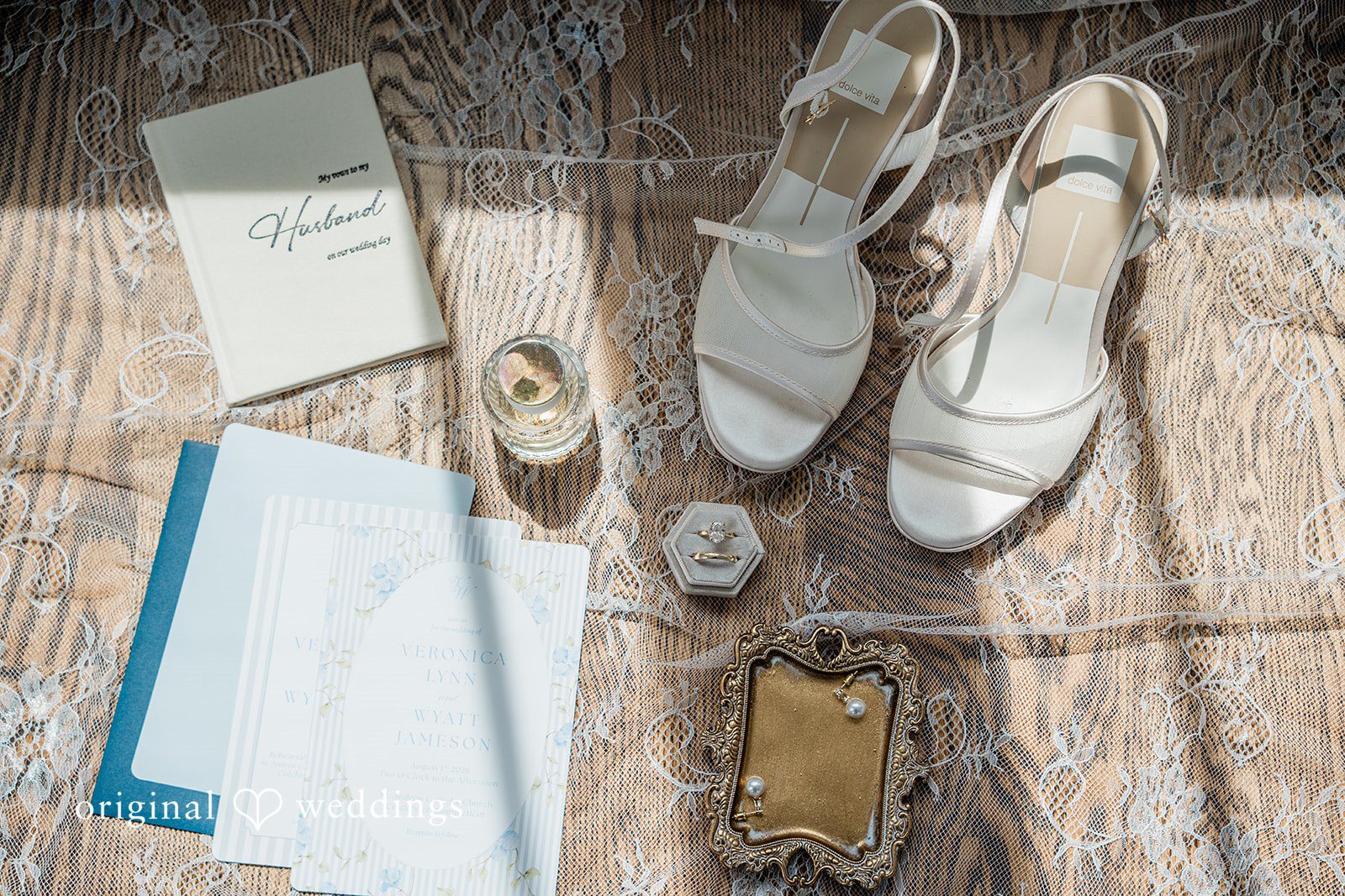 Veronica + Wyatt An overhead view of bridal accessories including shoes, invitations, and jewelry.