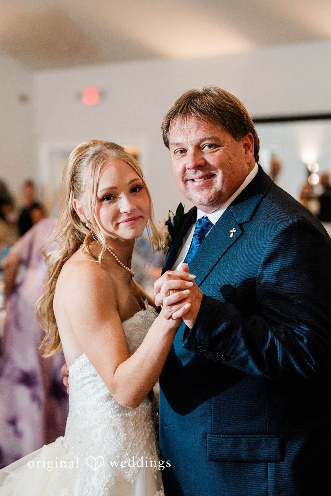 Veronica + Wyatt A smiling bride dancing with a man in a dark suit jacket at the reception.