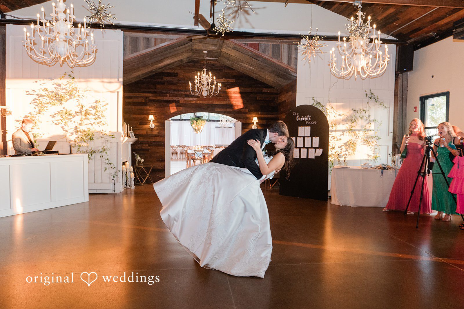 Paige + Stephen A bride in a full white gown spinning alone on an open wooden dance floor.