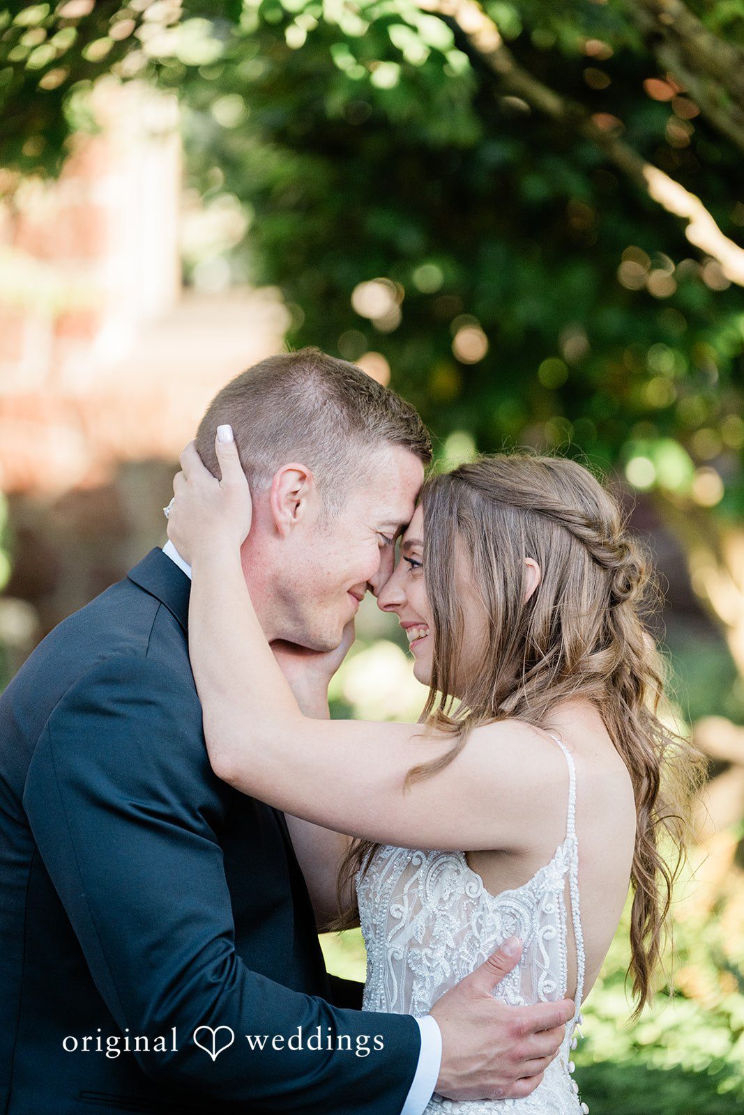 A groom holding his bride close as they share a joyful moment together.