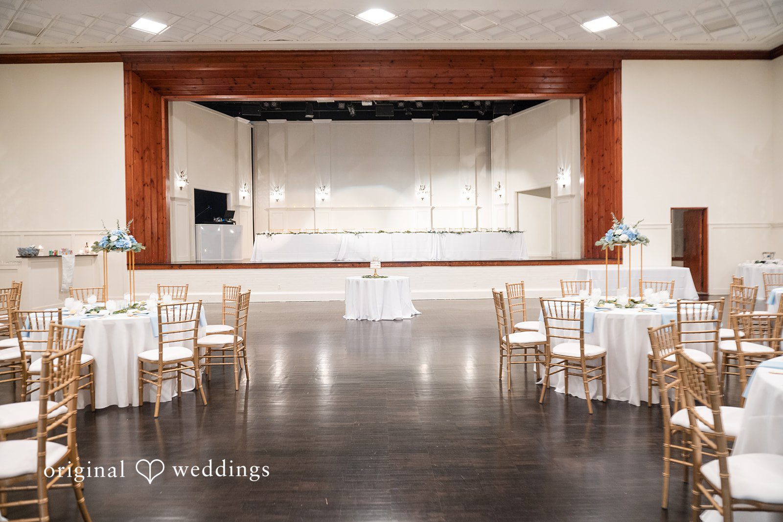 Jaclyn + Mason Empty ballroom dance floor surrounded by reception tables.