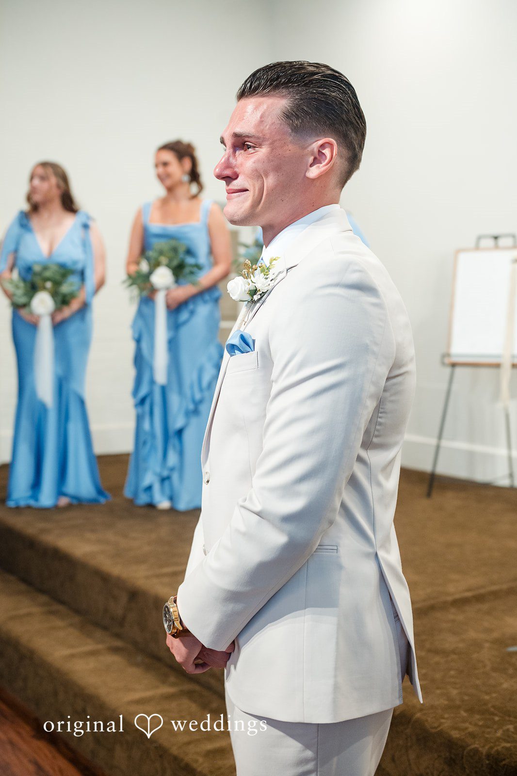 Jaclyn + Mason Groom in a white suit standing near bridesmaids.